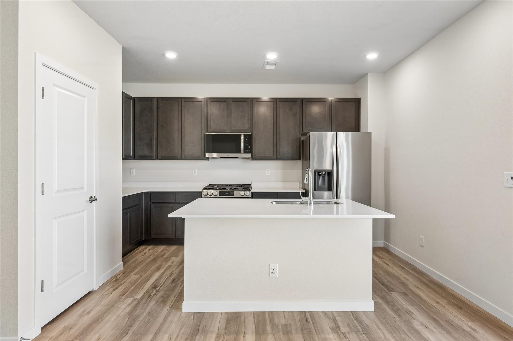 A kitchen with black cabinets.
