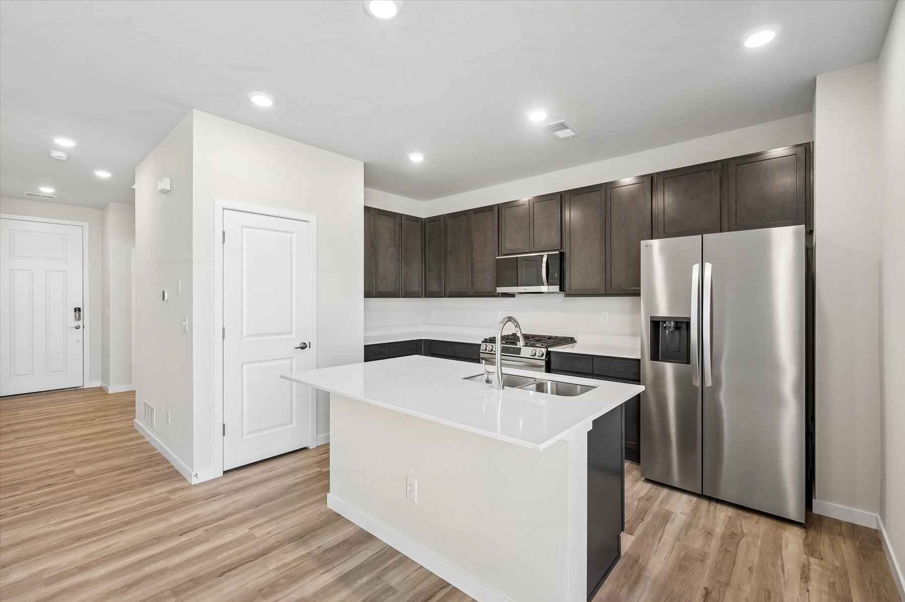 A kitchen with a fridge and cabinets.