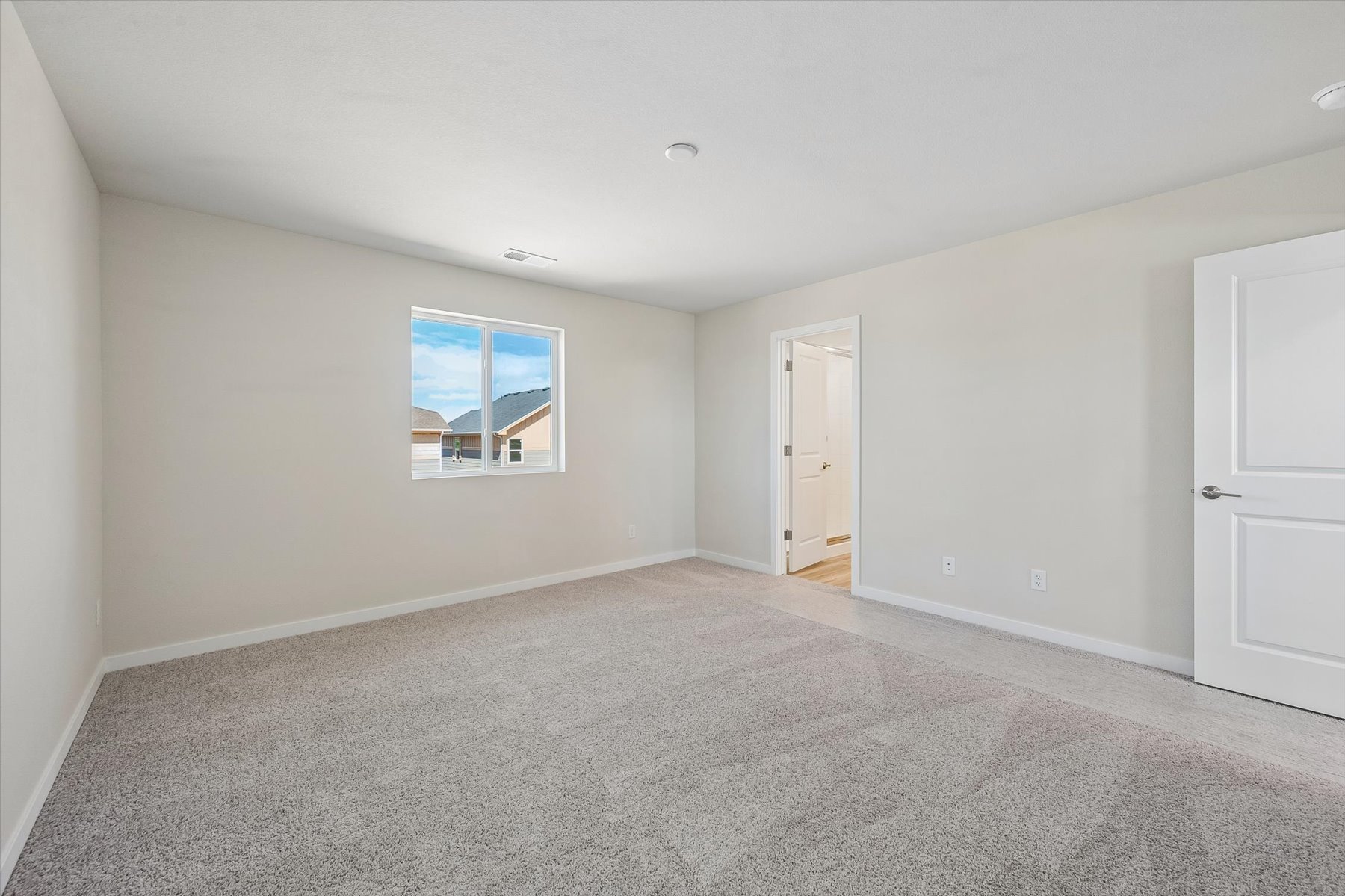 A room with a window and a carpet.