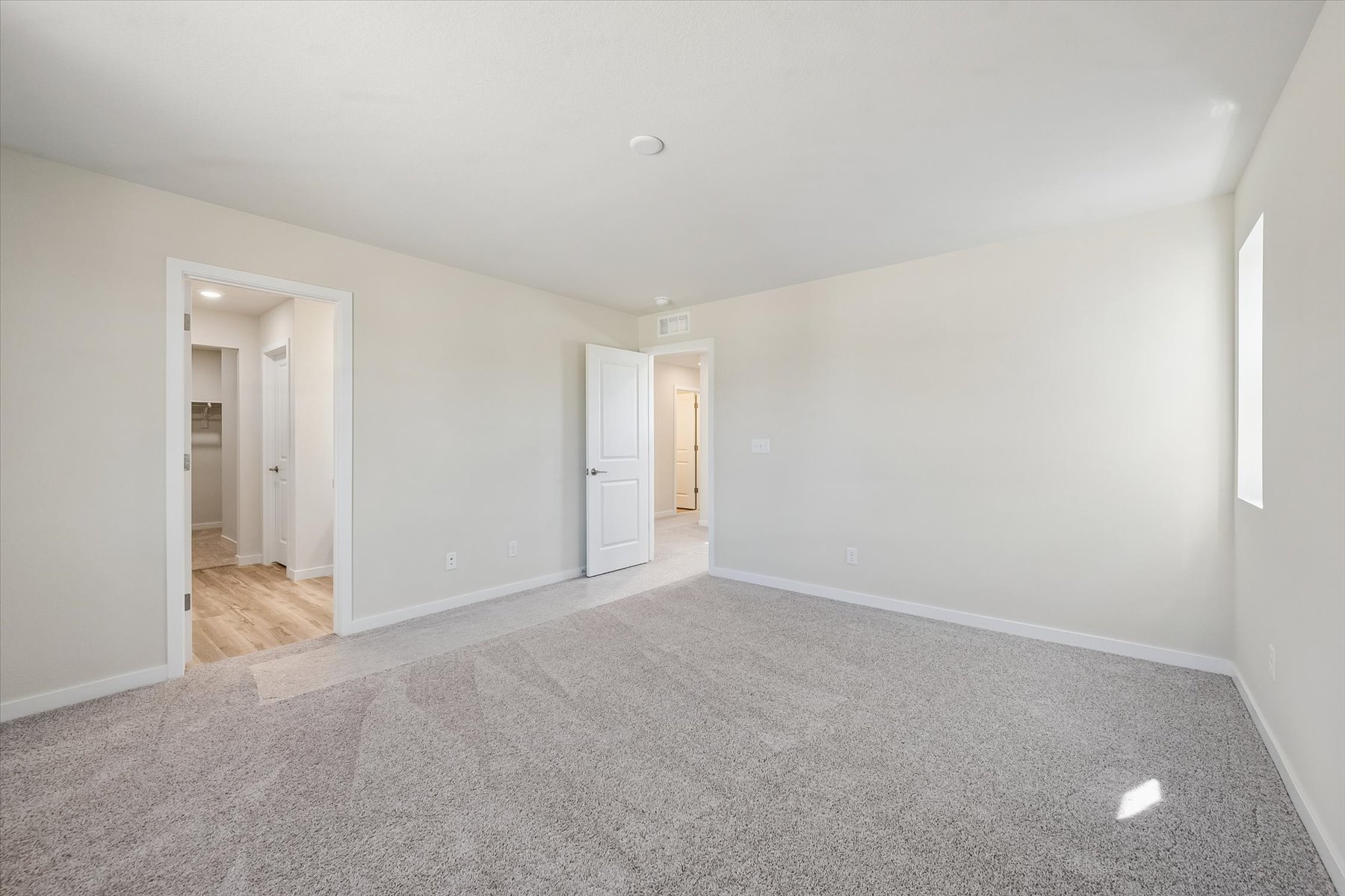 A long hallway with white walls.