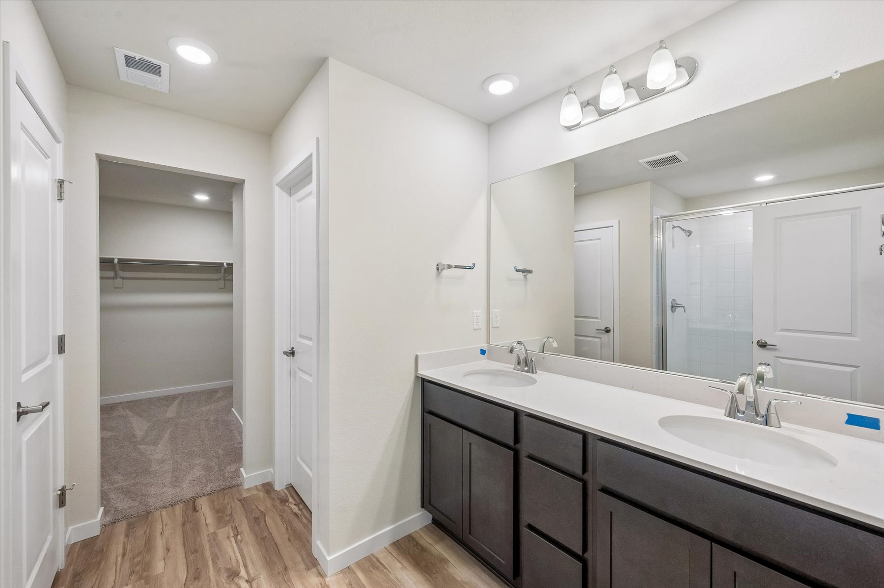 A bathroom with a large mirror.