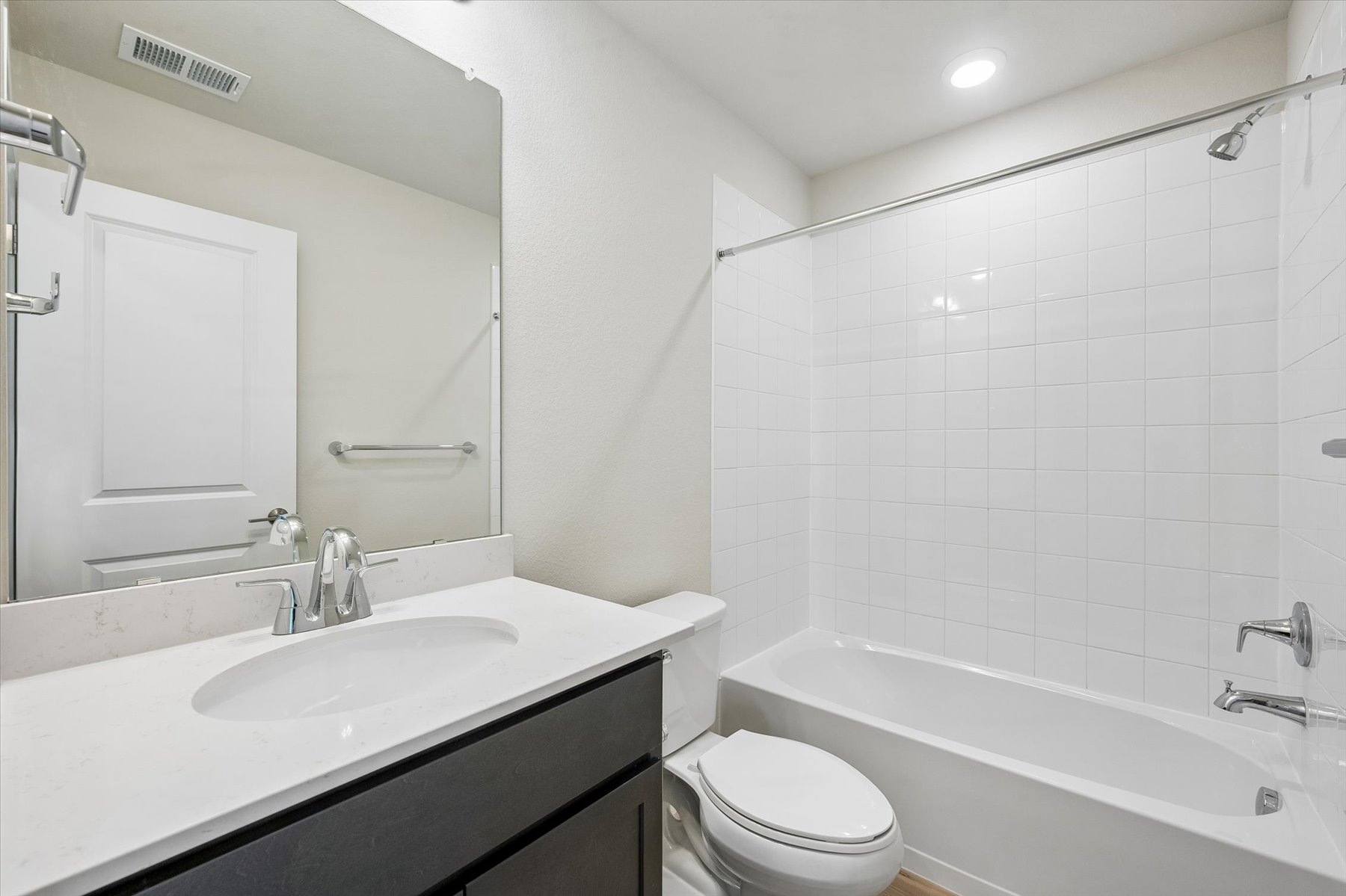 A bathroom with a tub sink and toilet.