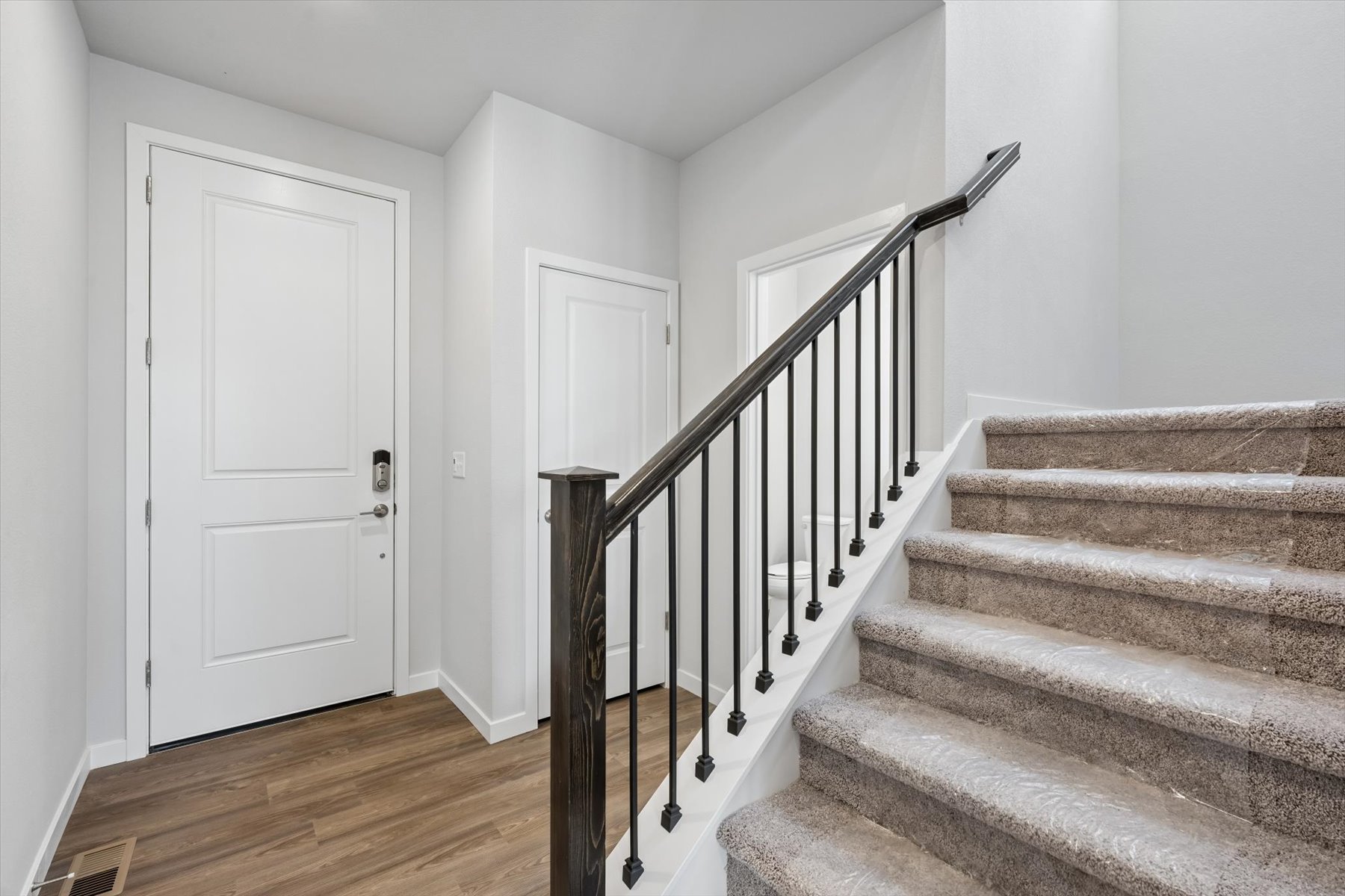 A staircase with white doors.