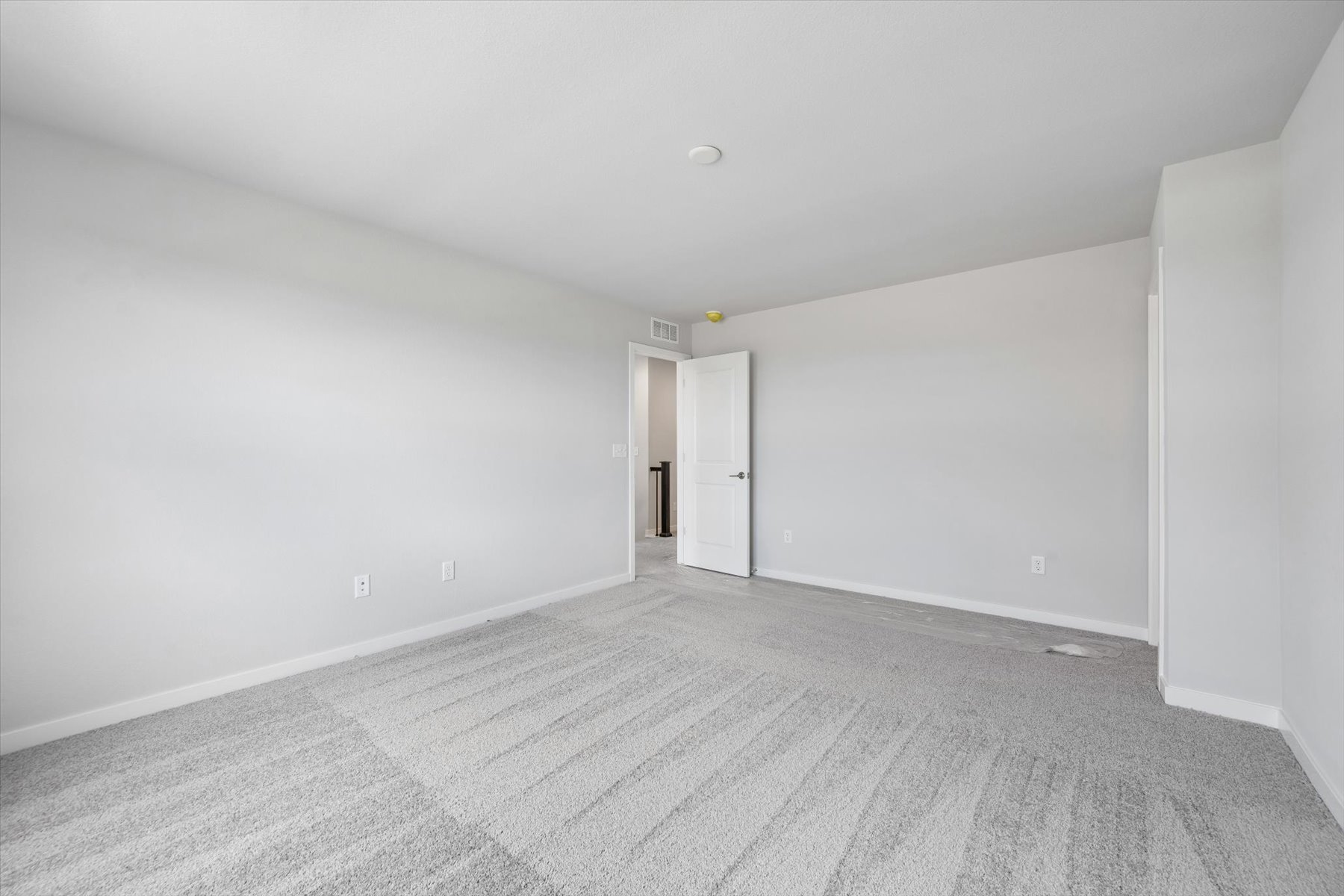 A hallway with white walls.