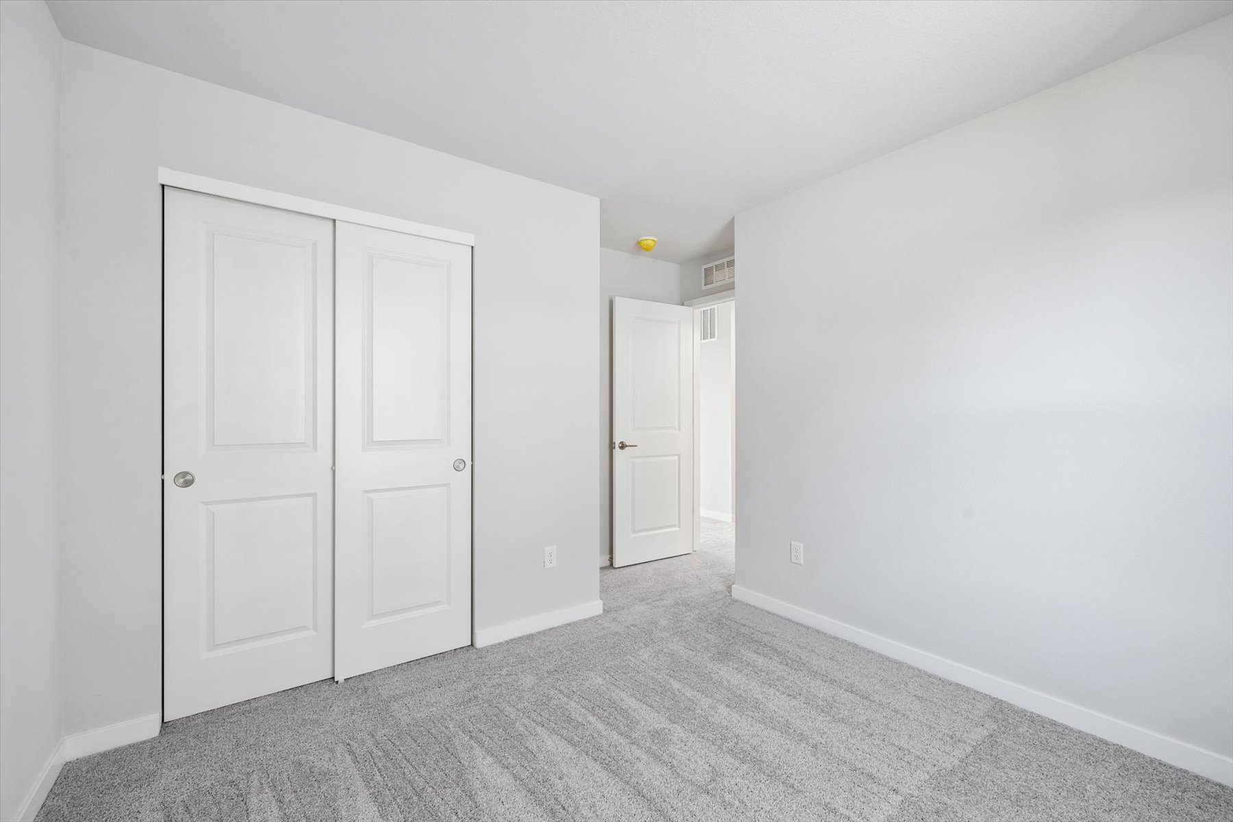 A hallway with white doors.