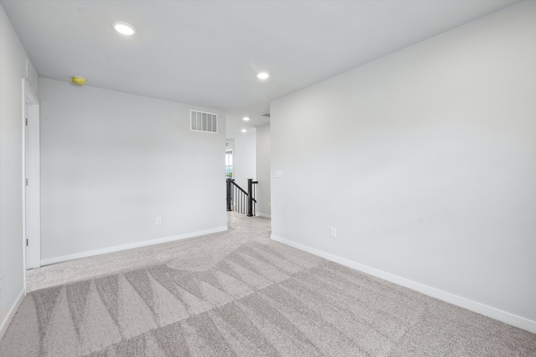 A hallway with white walls.