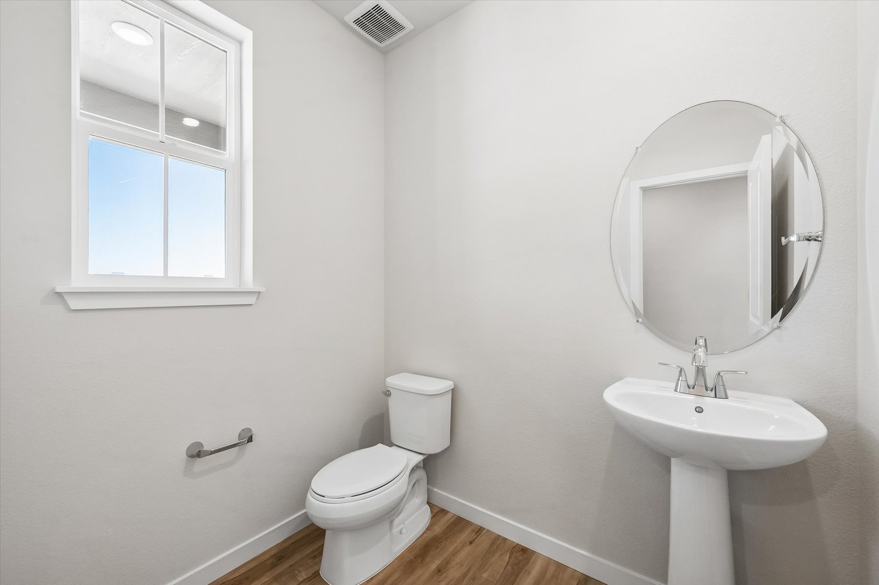 A bathroom with a toilet and sink.