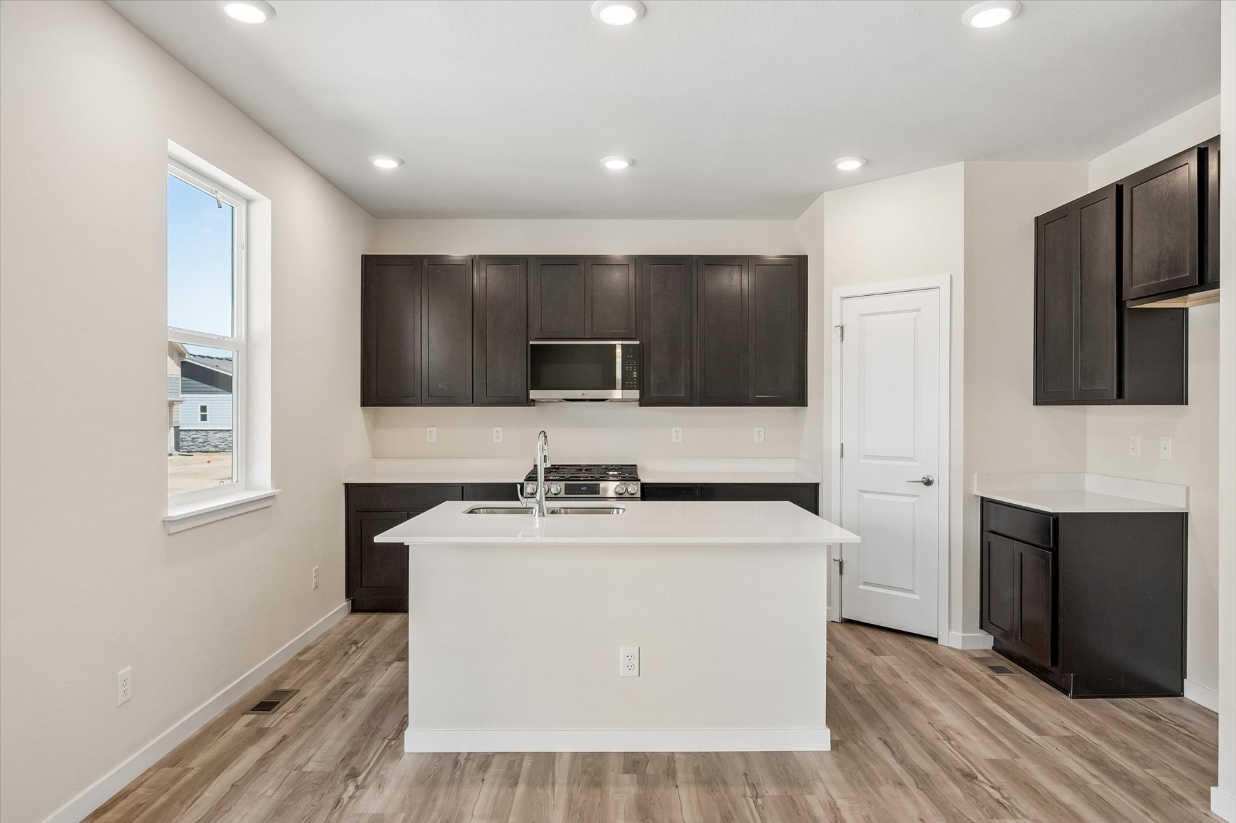 A kitchen with black cabinets.