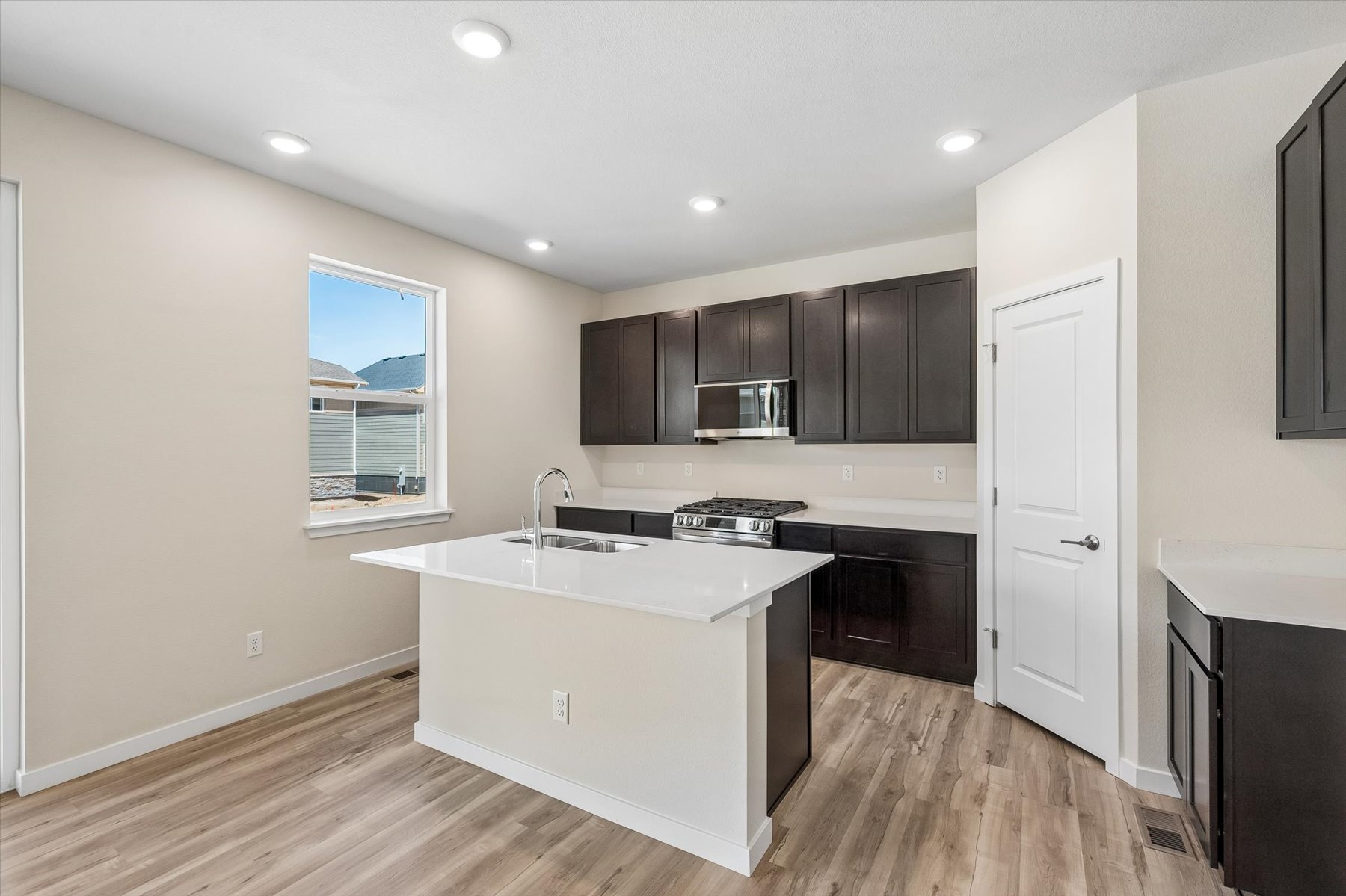 A kitchen with black cabinets.