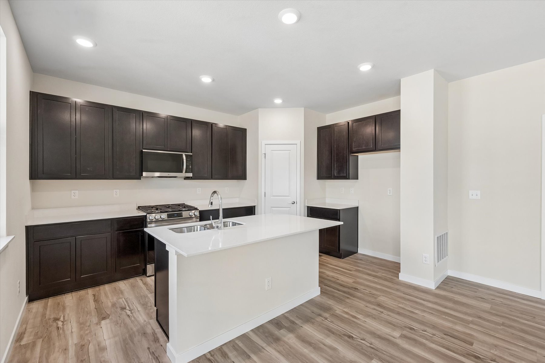 A kitchen with black cabinets.