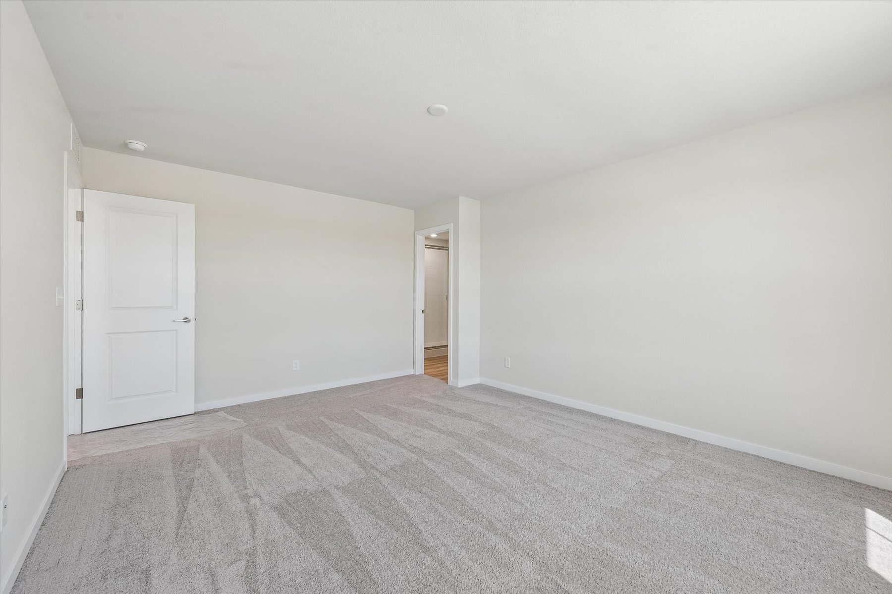 A hallway with white doors.
