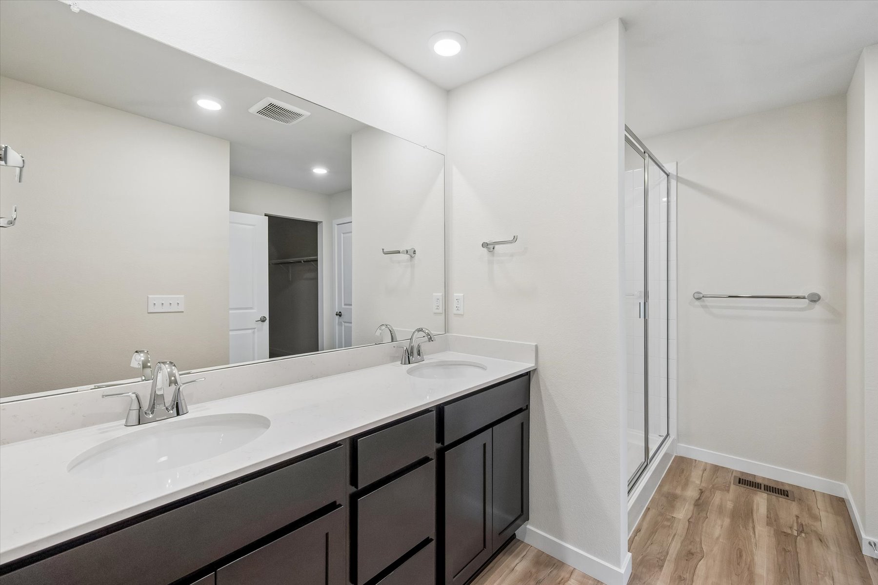 A bathroom with a sink and shower.