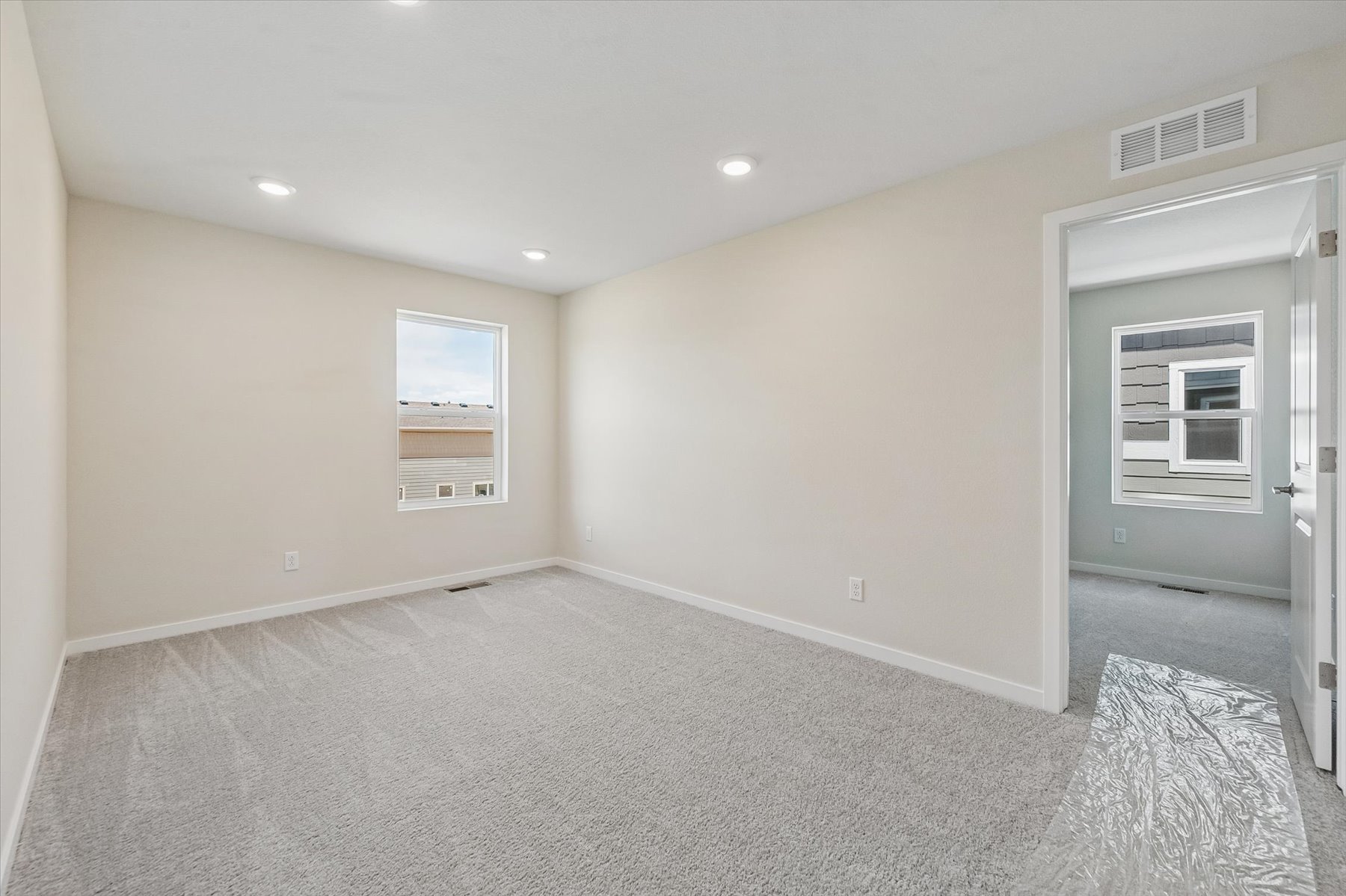 A room with a carpet and a rug.