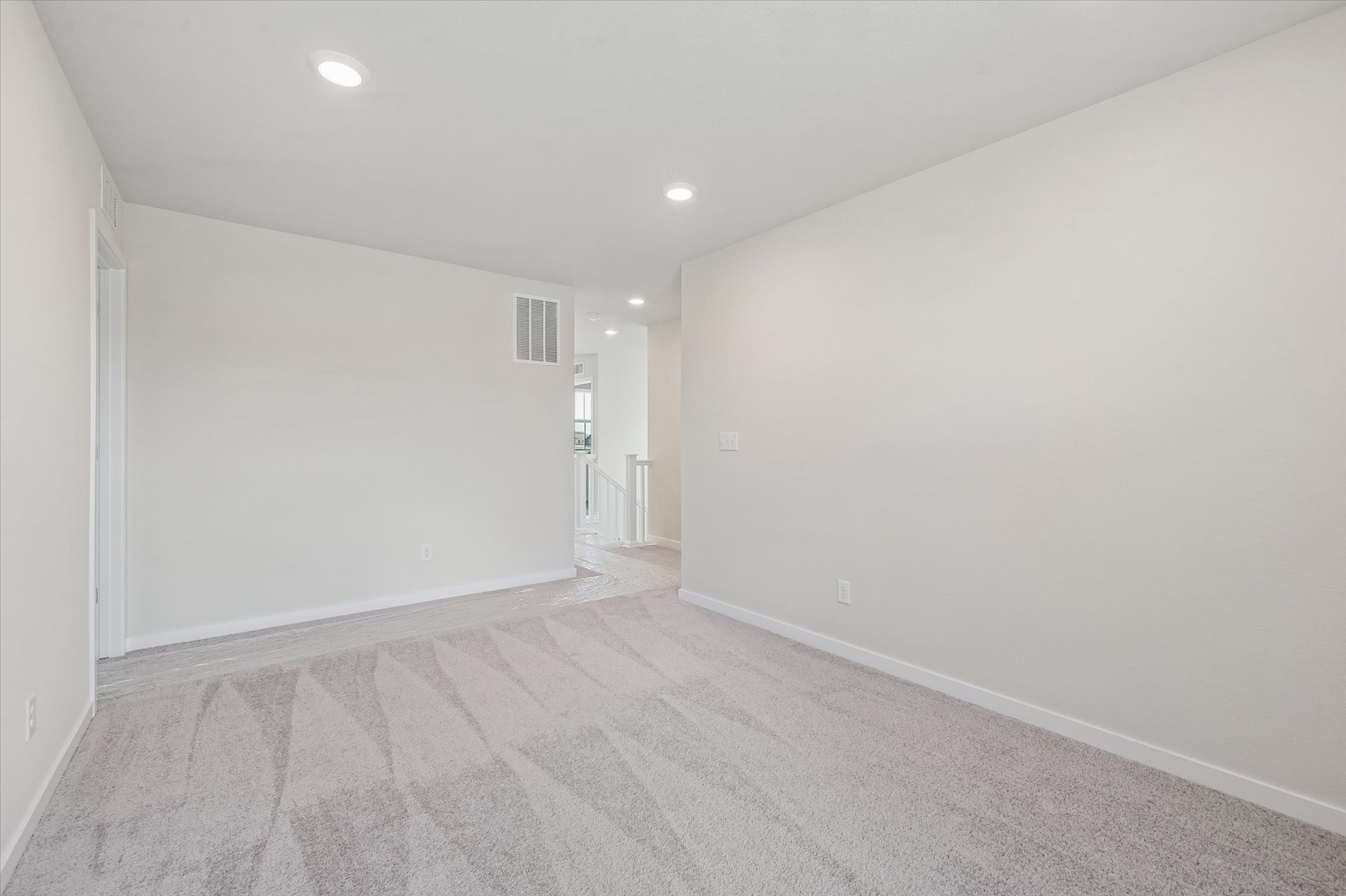 A long hallway with white walls.