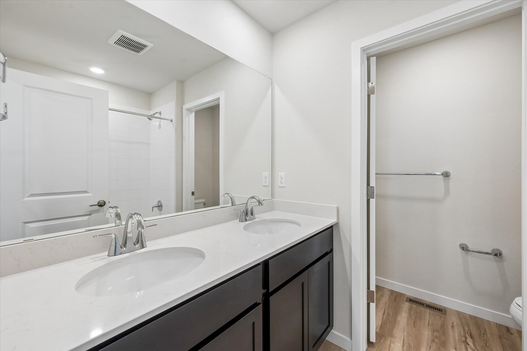 A bathroom with a sink and a shower.
