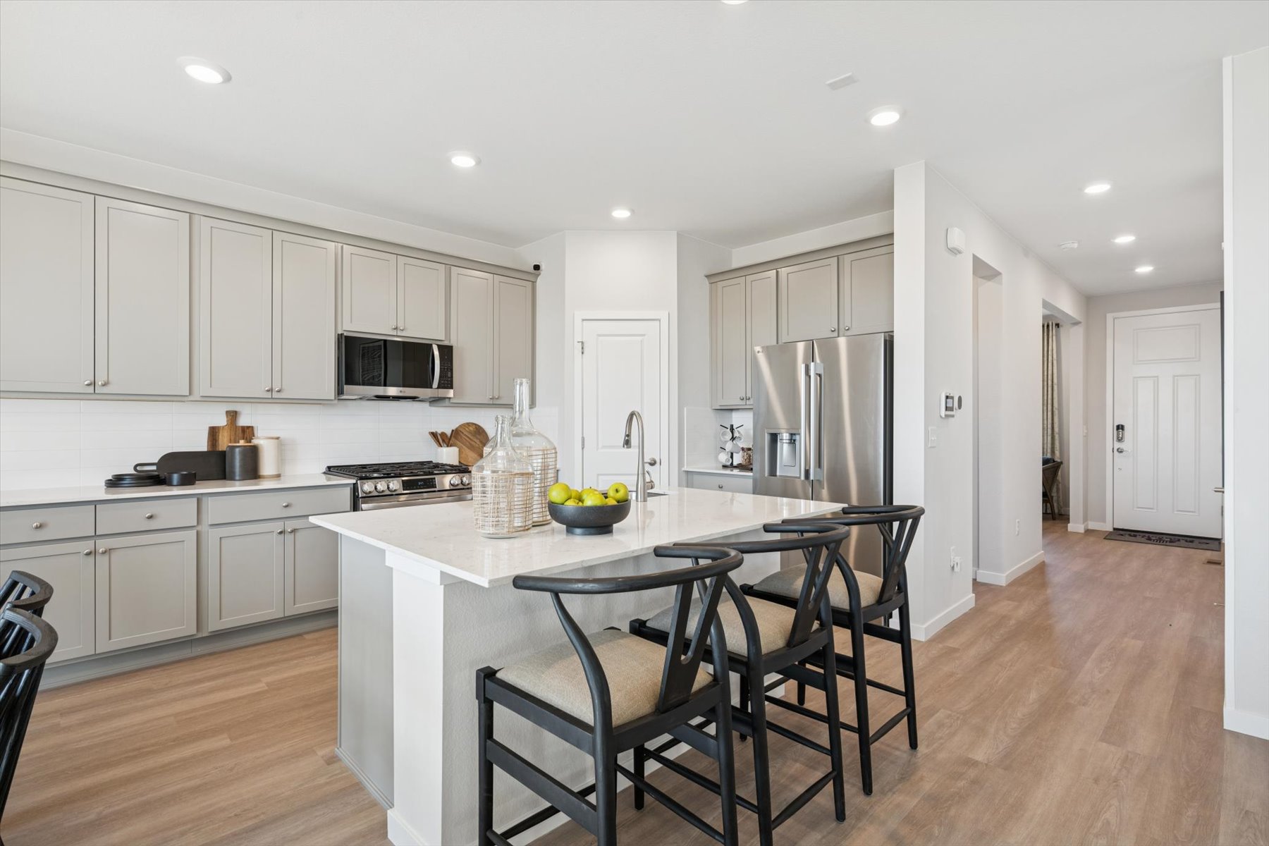 A kitchen with white cabinets.