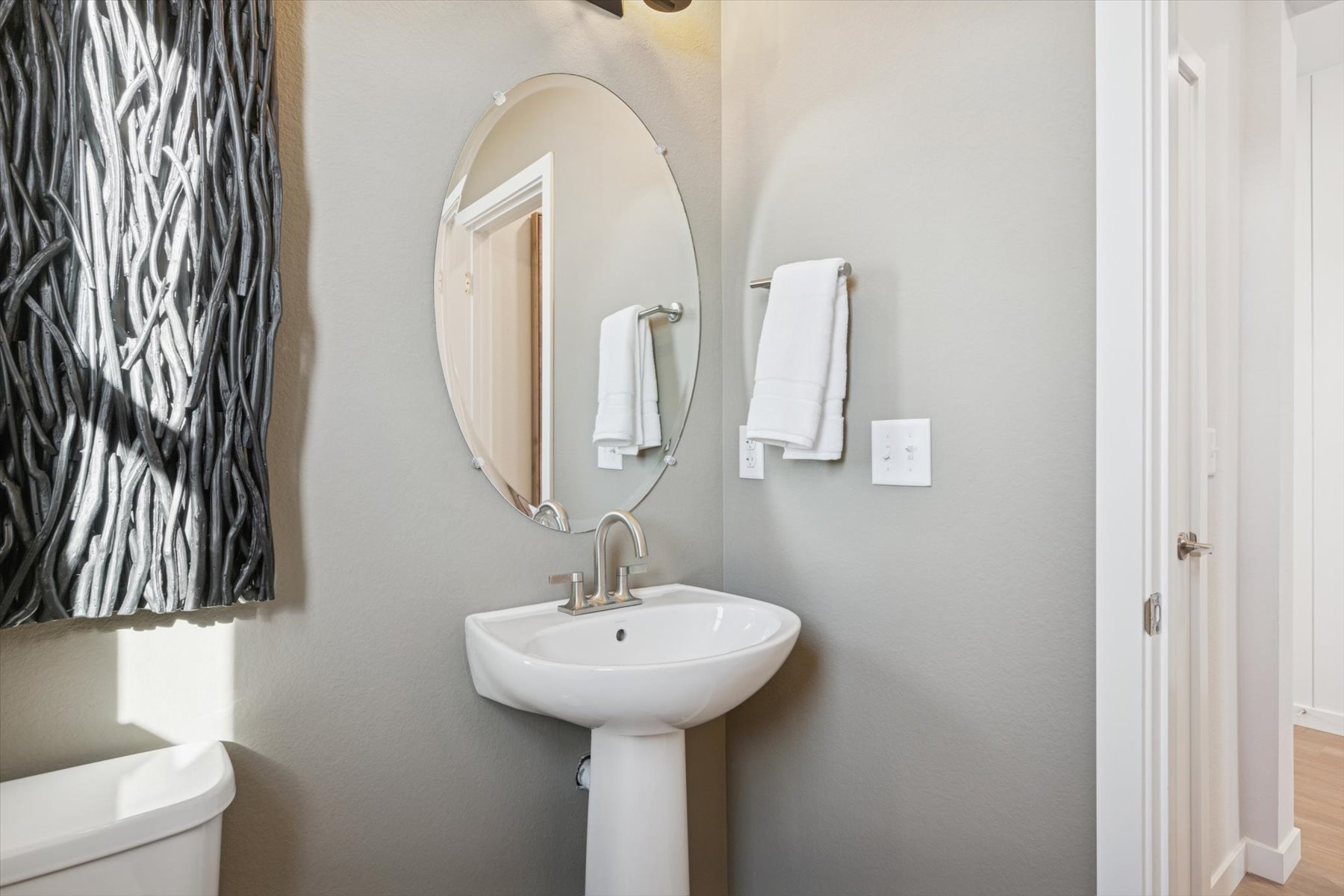 A bathroom with a mirror and sink.
