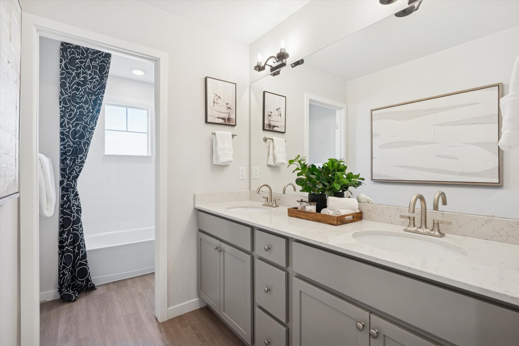 A bathroom with a sink and a mirror.