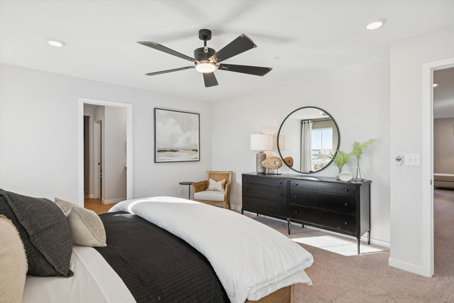 A bedroom with a large mirror.