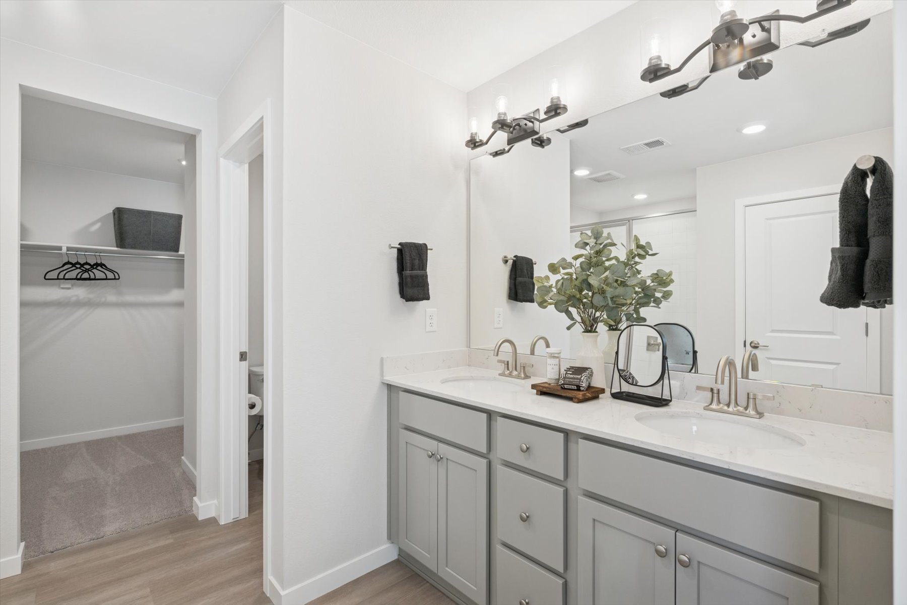 A bathroom with a large mirror.