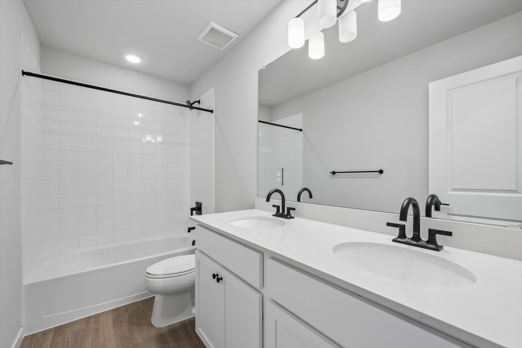 A bathroom with a tub sink and toilet.