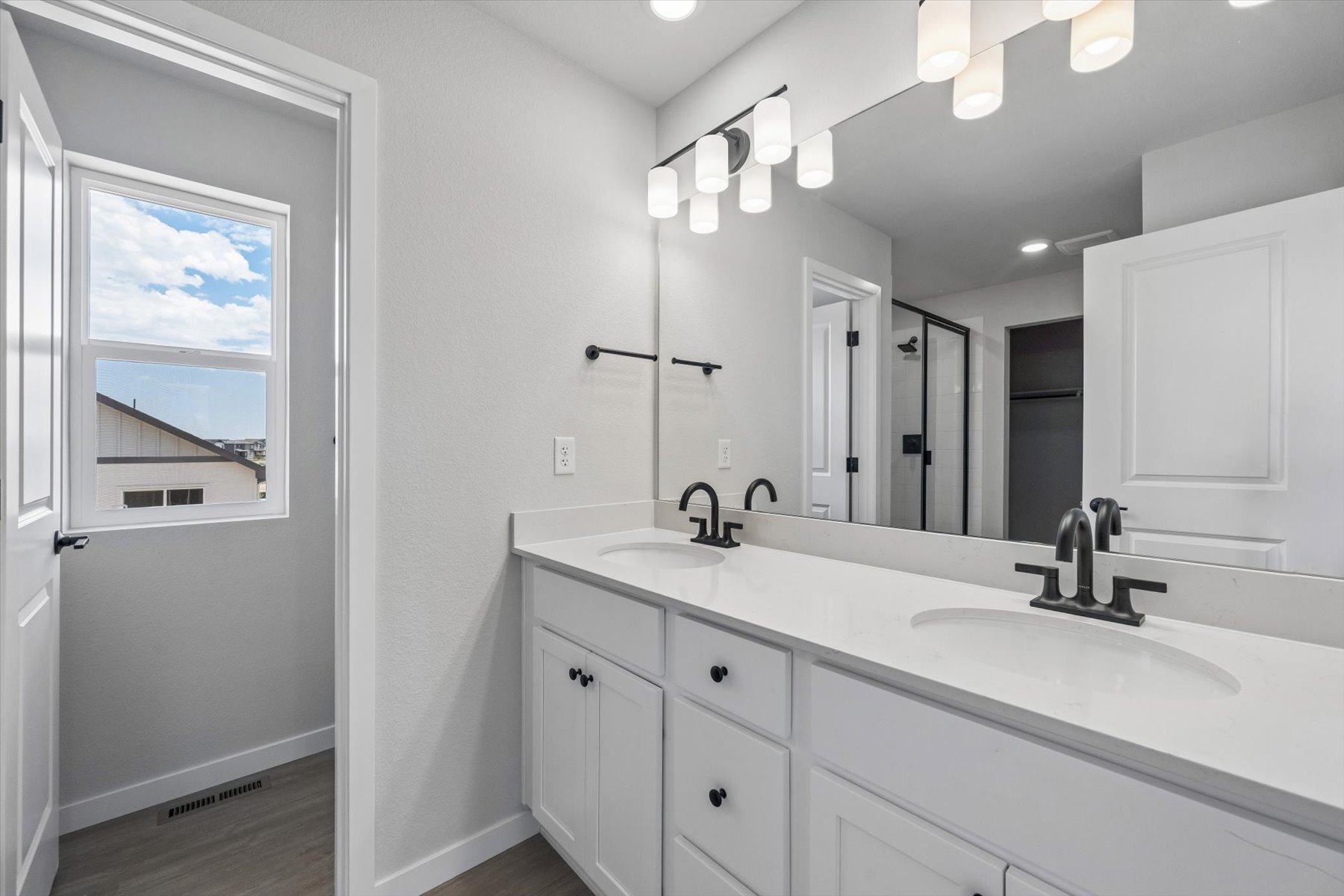 A bathroom with a large mirror.