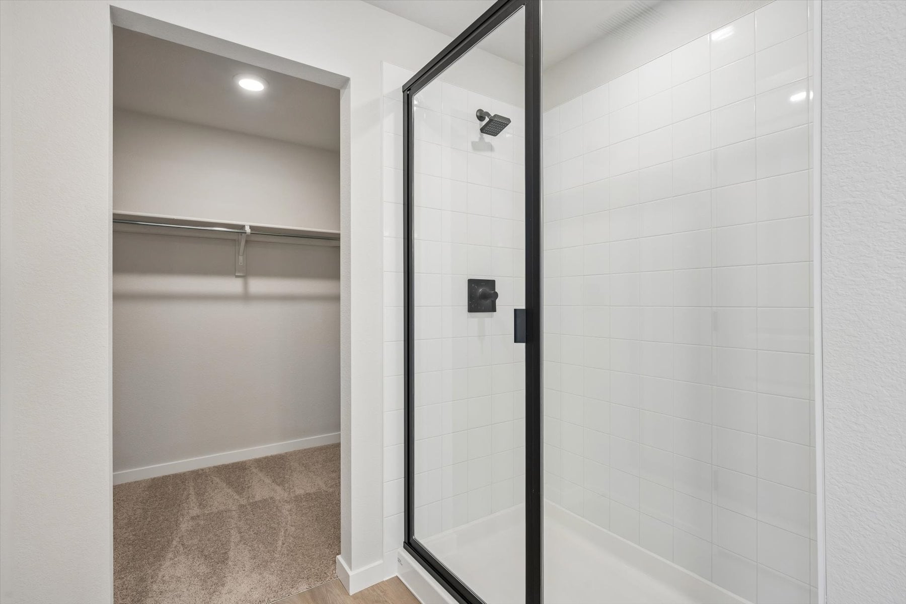 A shower with a glass door.