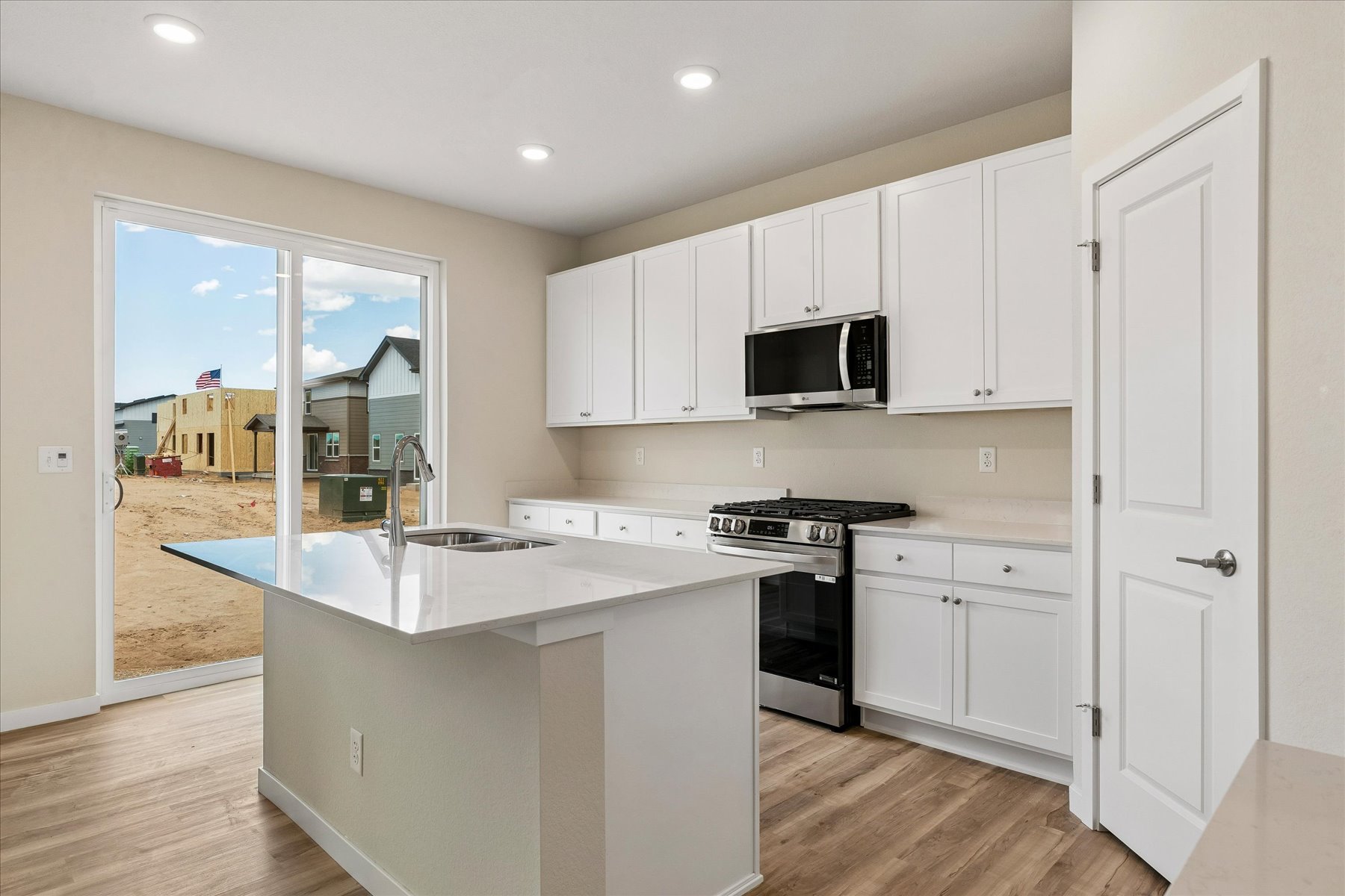 A kitchen with white cabinets.