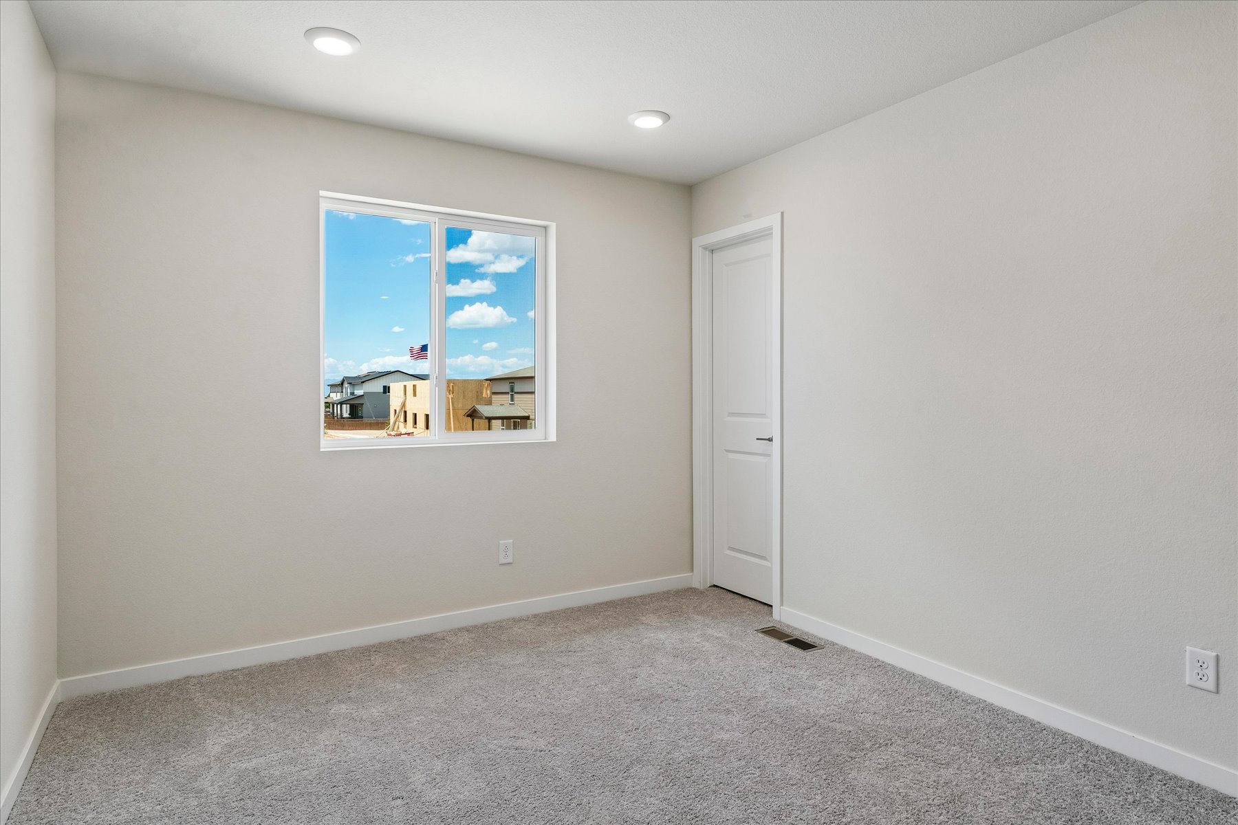 A room with a window and a door.
