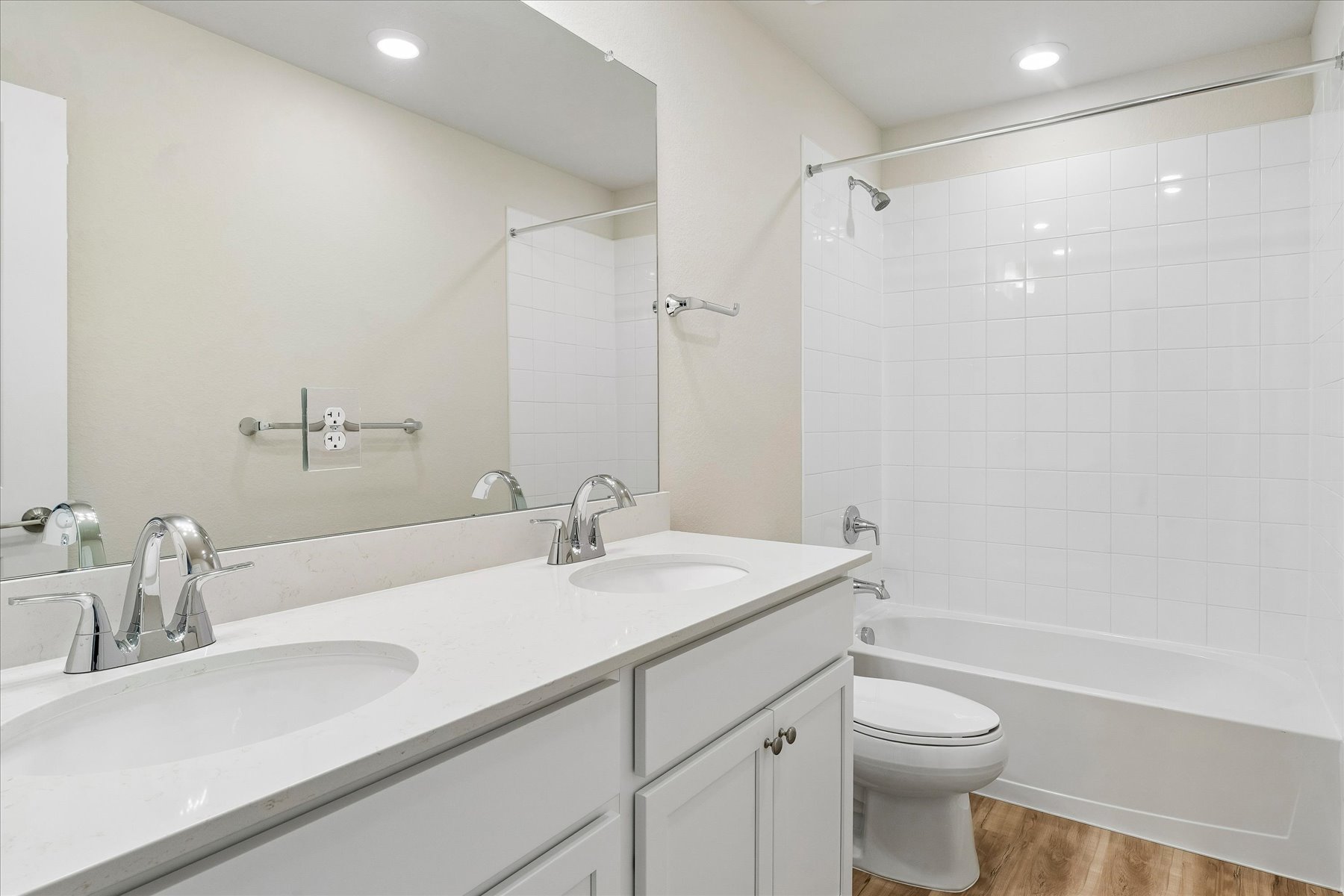 A bathroom with a tub sink and toilet.