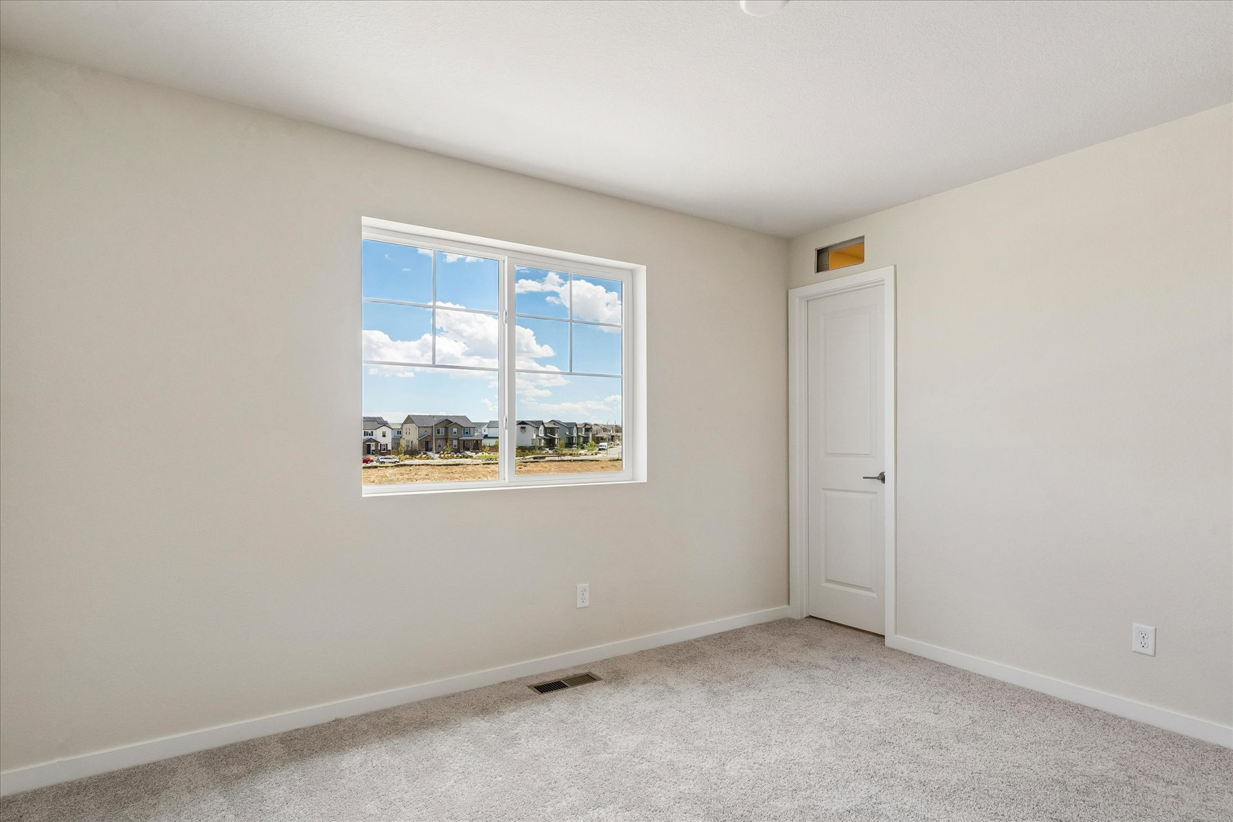A room with a window and a door.