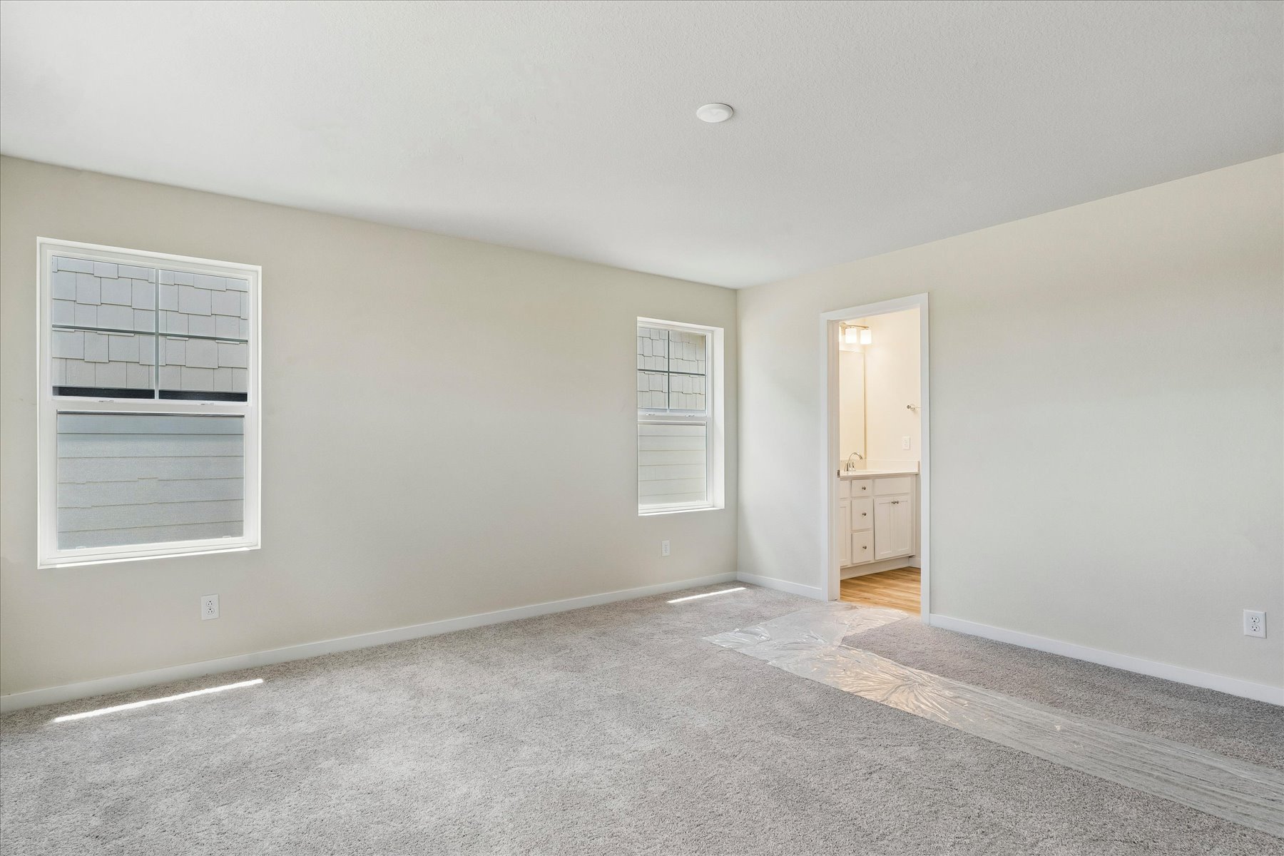 A room with a carpet and a door.