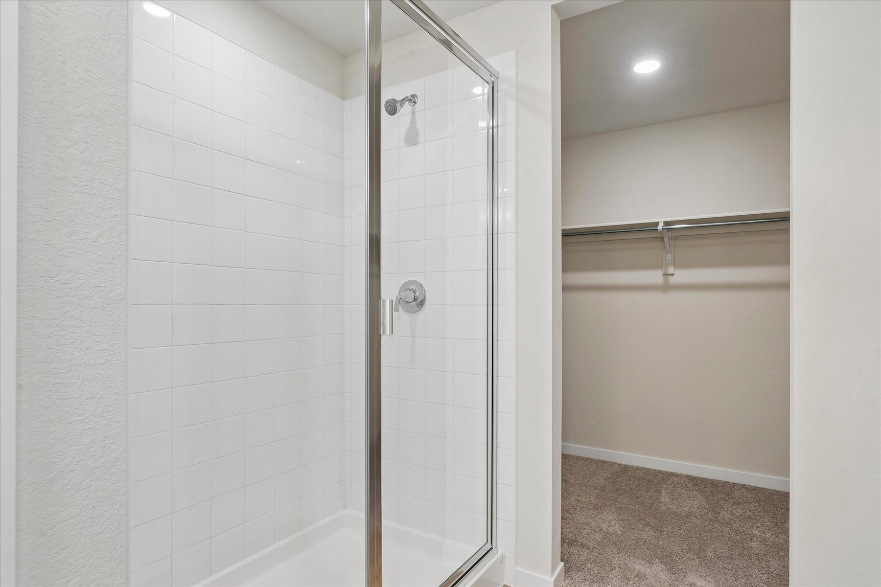 A shower with a glass door.