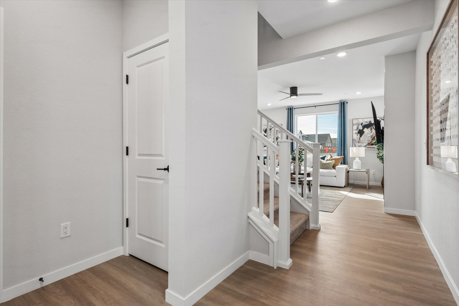 A room with white walls and a wood floor.