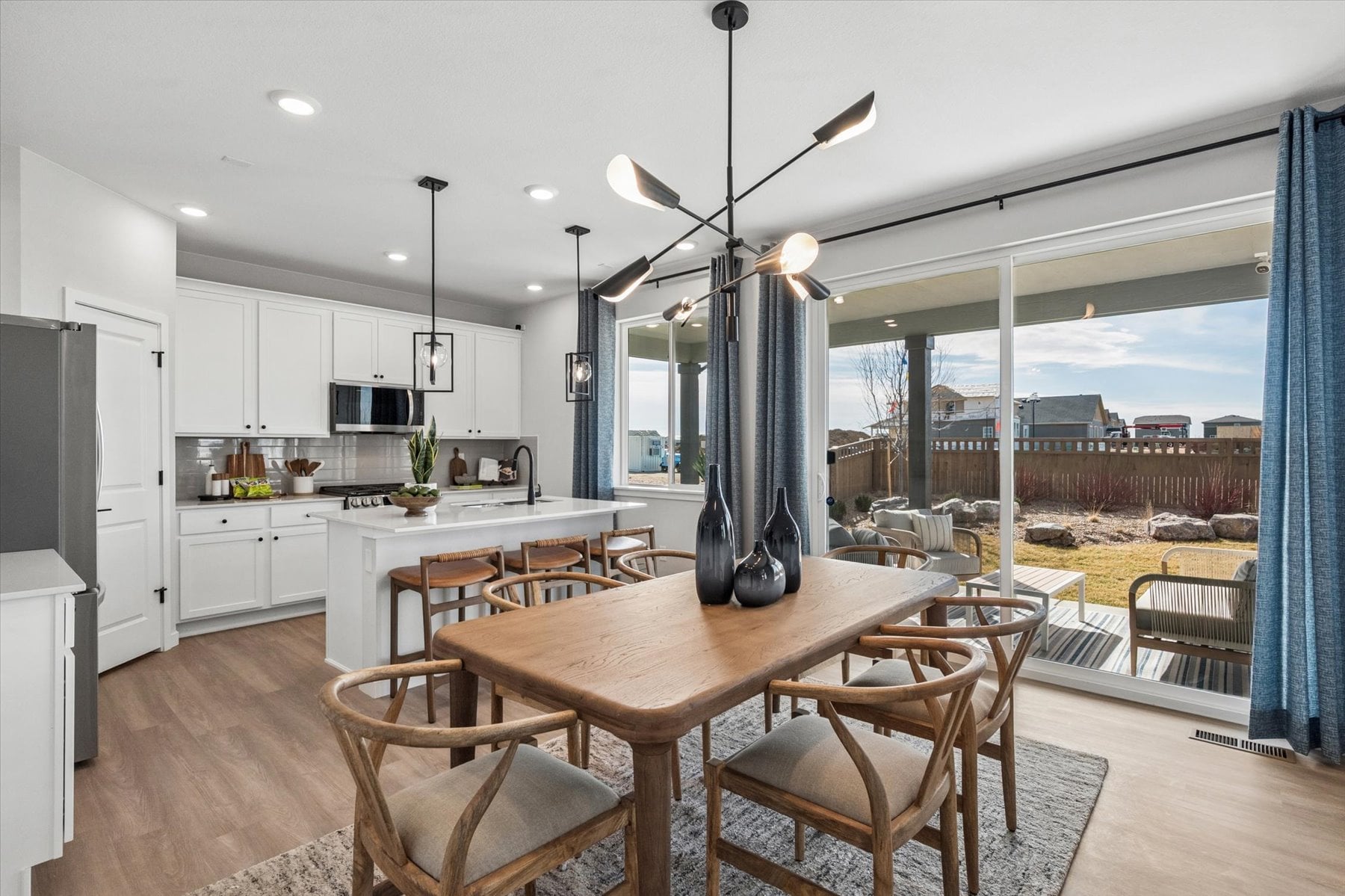 A kitchen with a dining table and a large window.