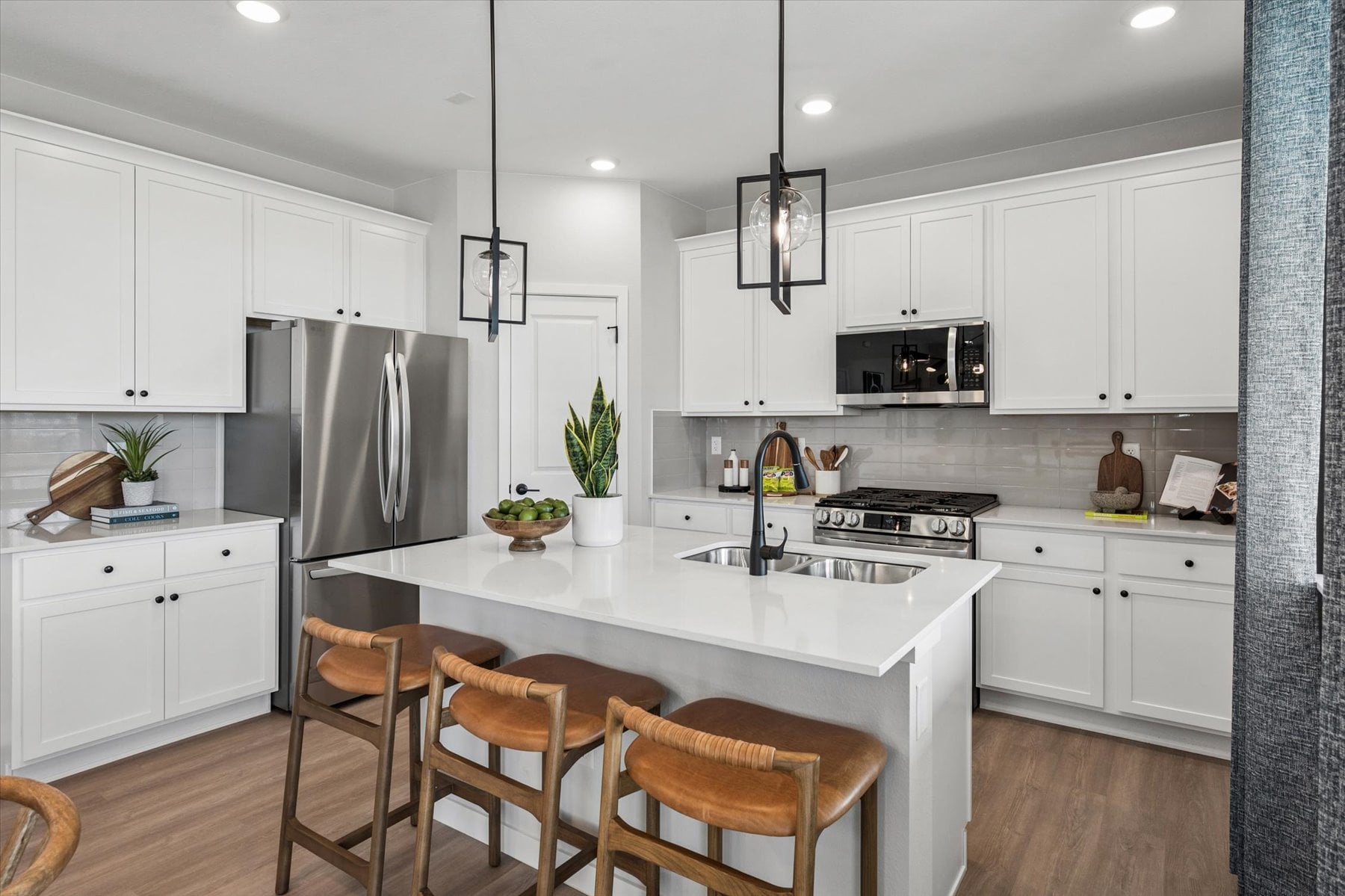 A kitchen with white cabinets.