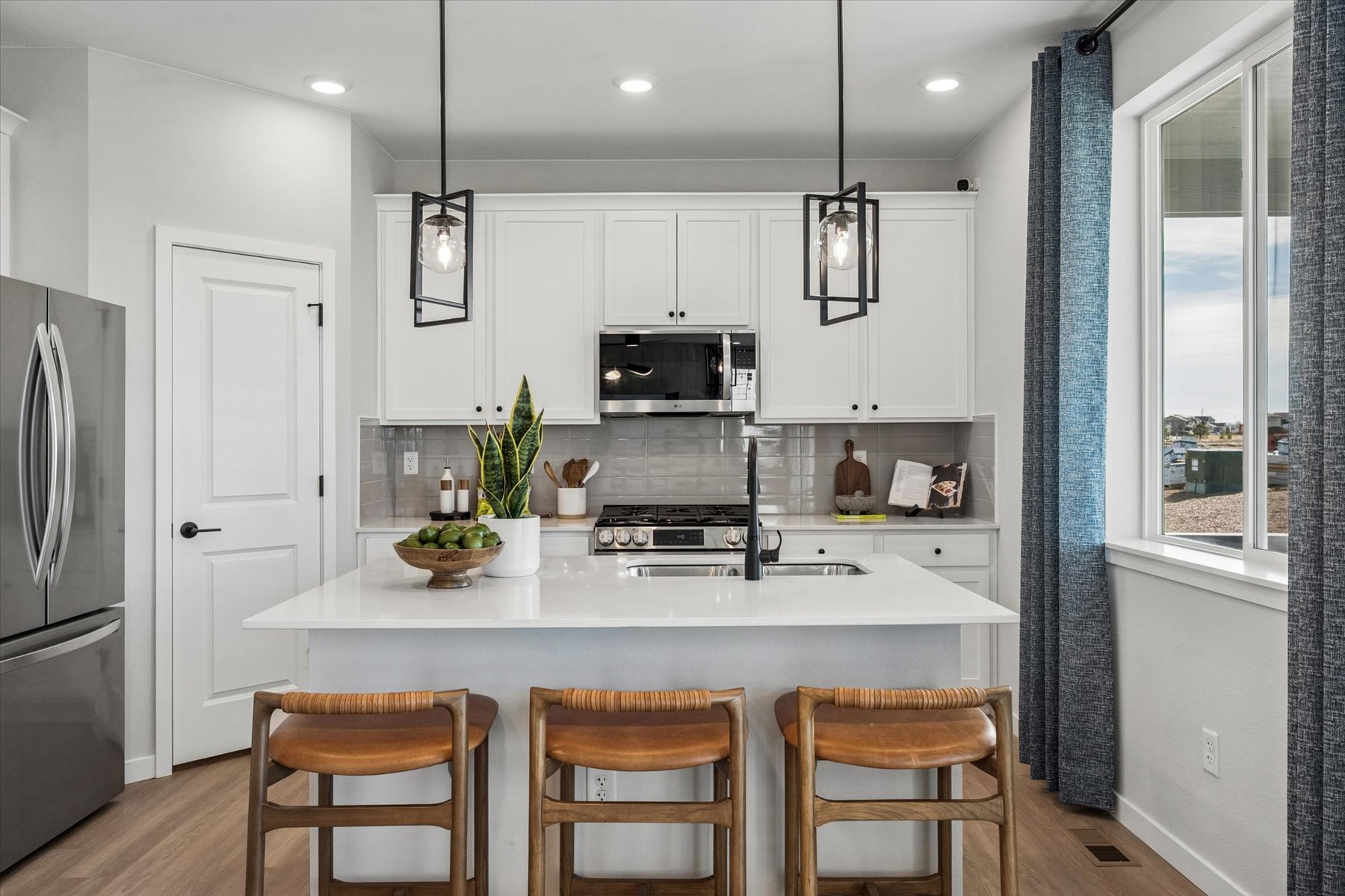 A kitchen with white cabinets.