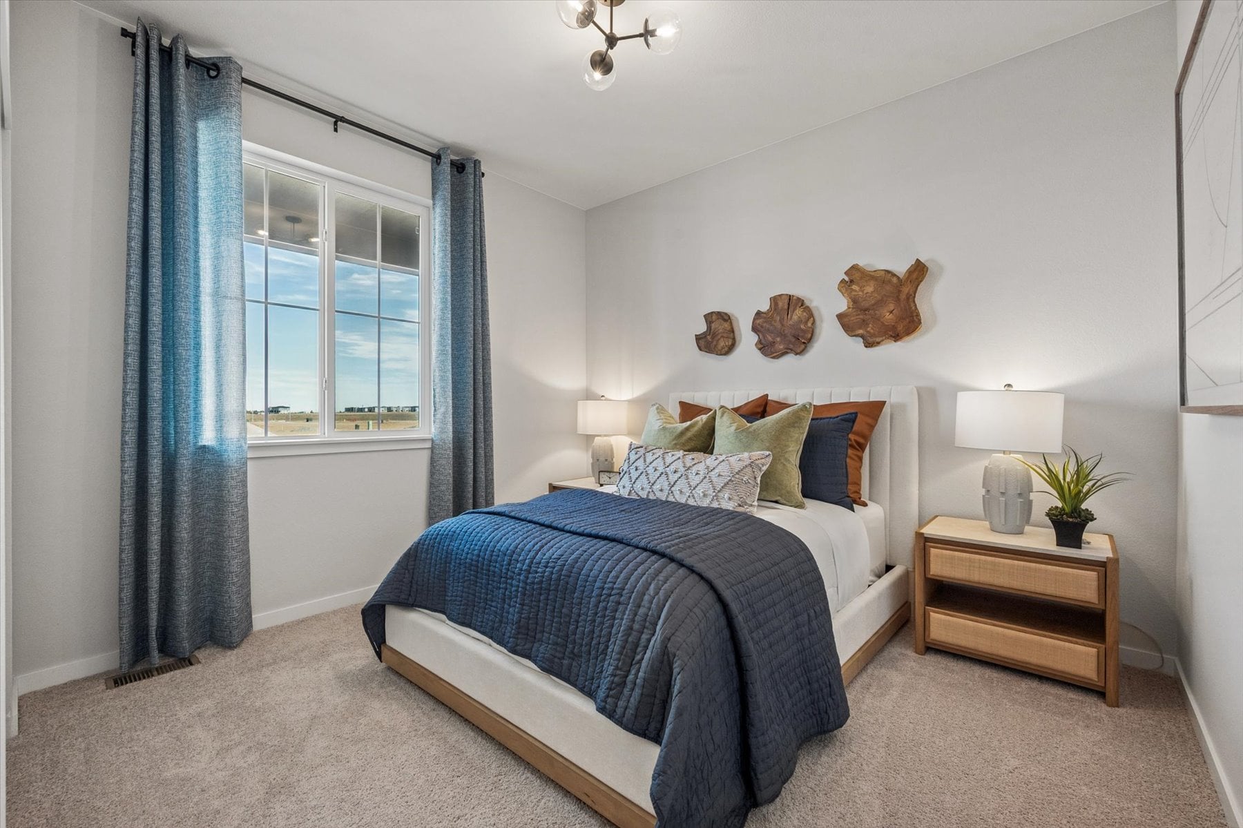 A bedroom with a bed and a table.