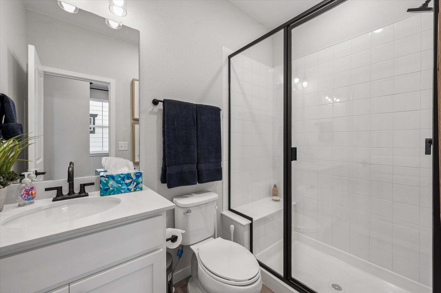 A bathroom with a shower and sink.