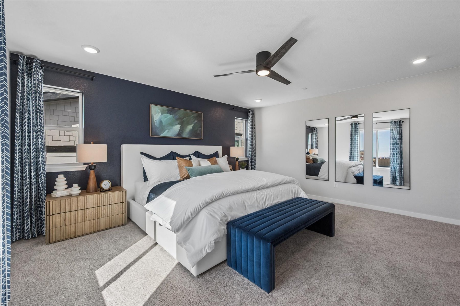 A bedroom with a bed and a bench.