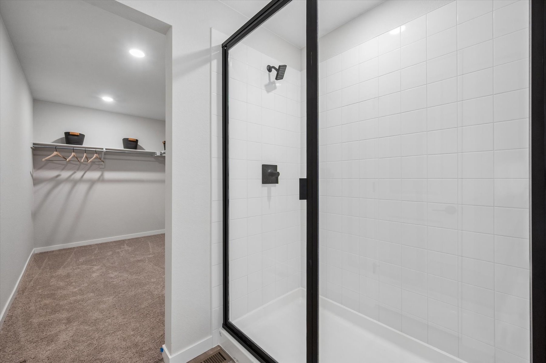 A shower with a glass door.
