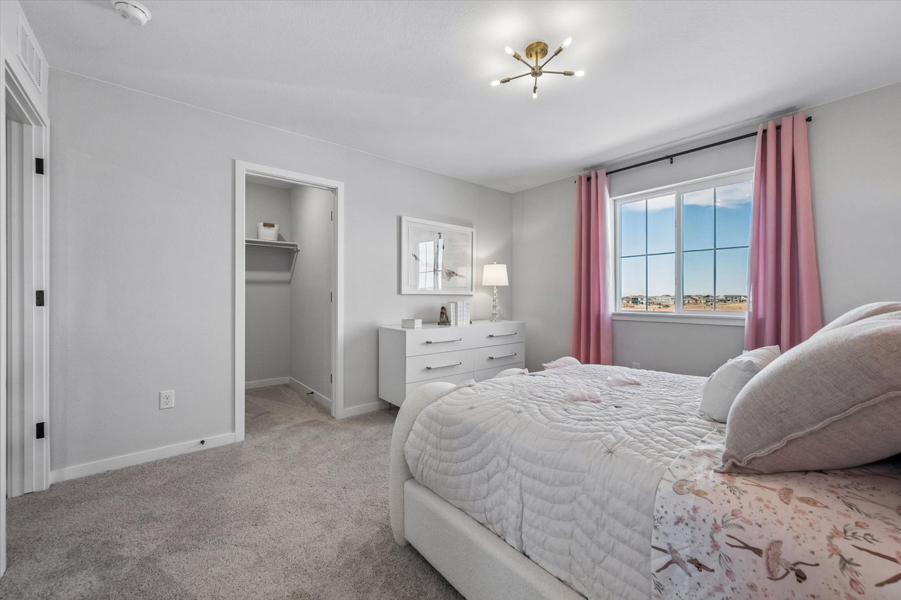 A bedroom with a bed and a window.