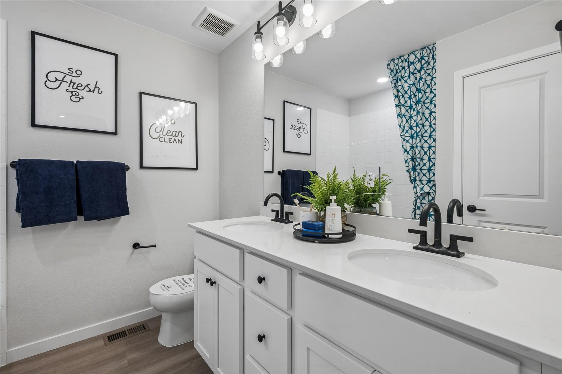 A bathroom with a sink and a toilet.