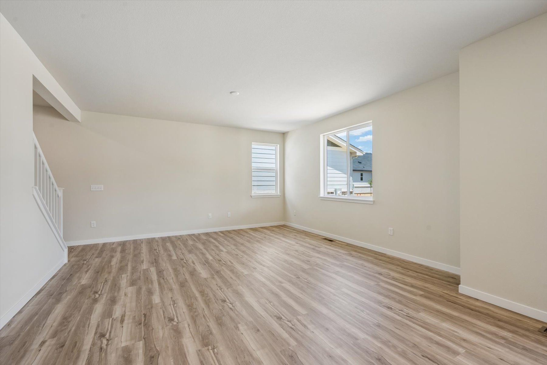 A room with a wood floor and a window.