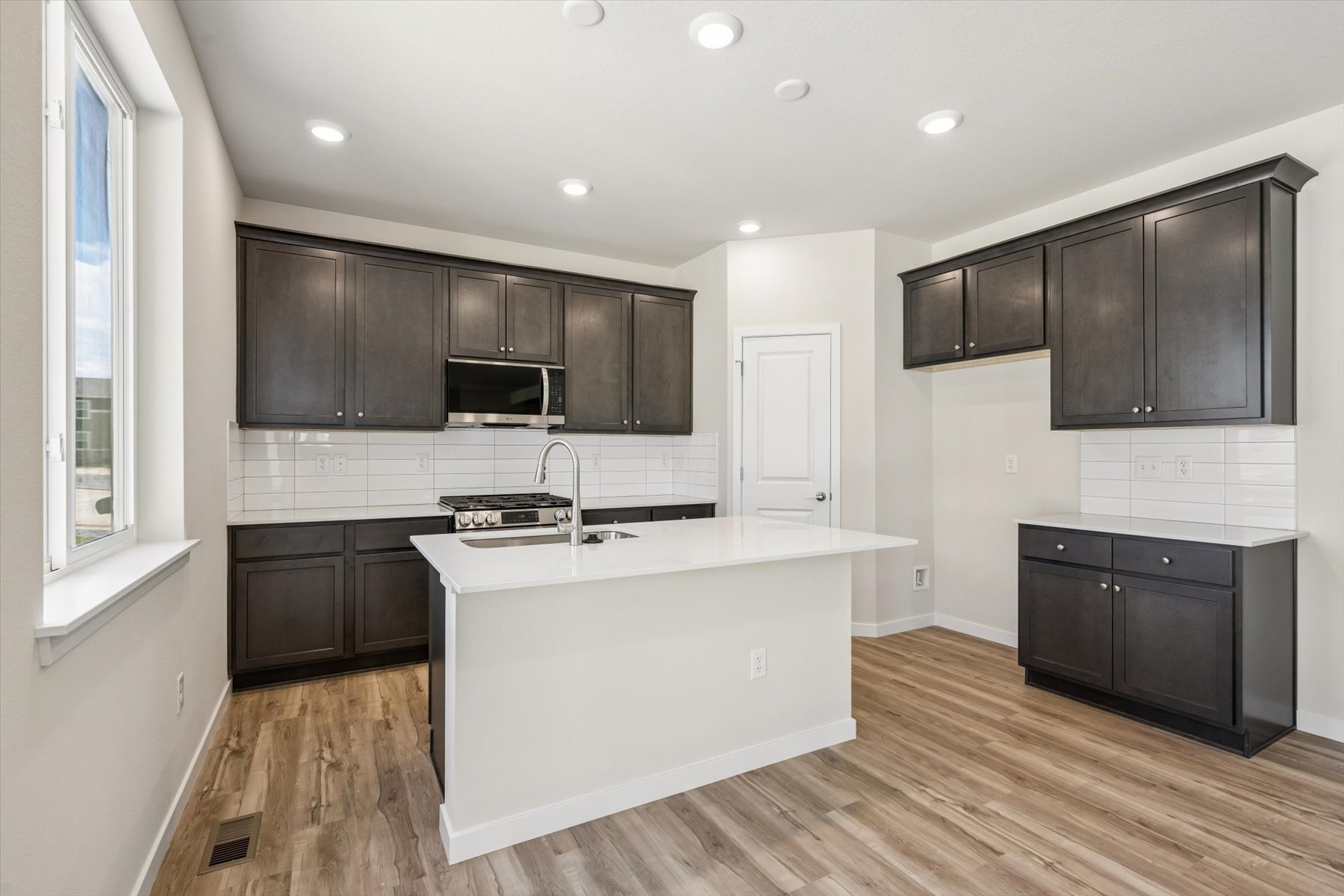 A kitchen with black cabinets.