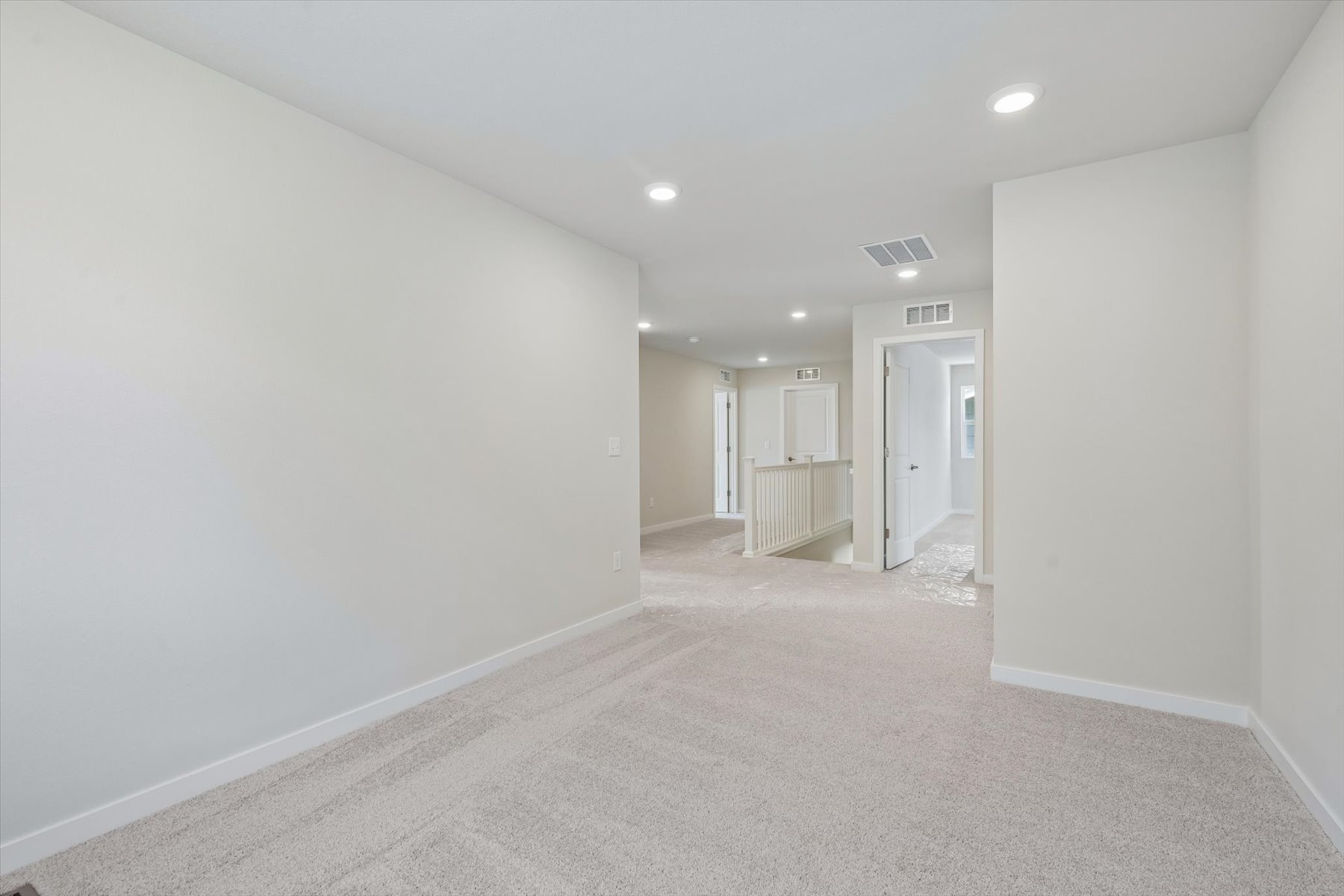 A long hallway with white walls.