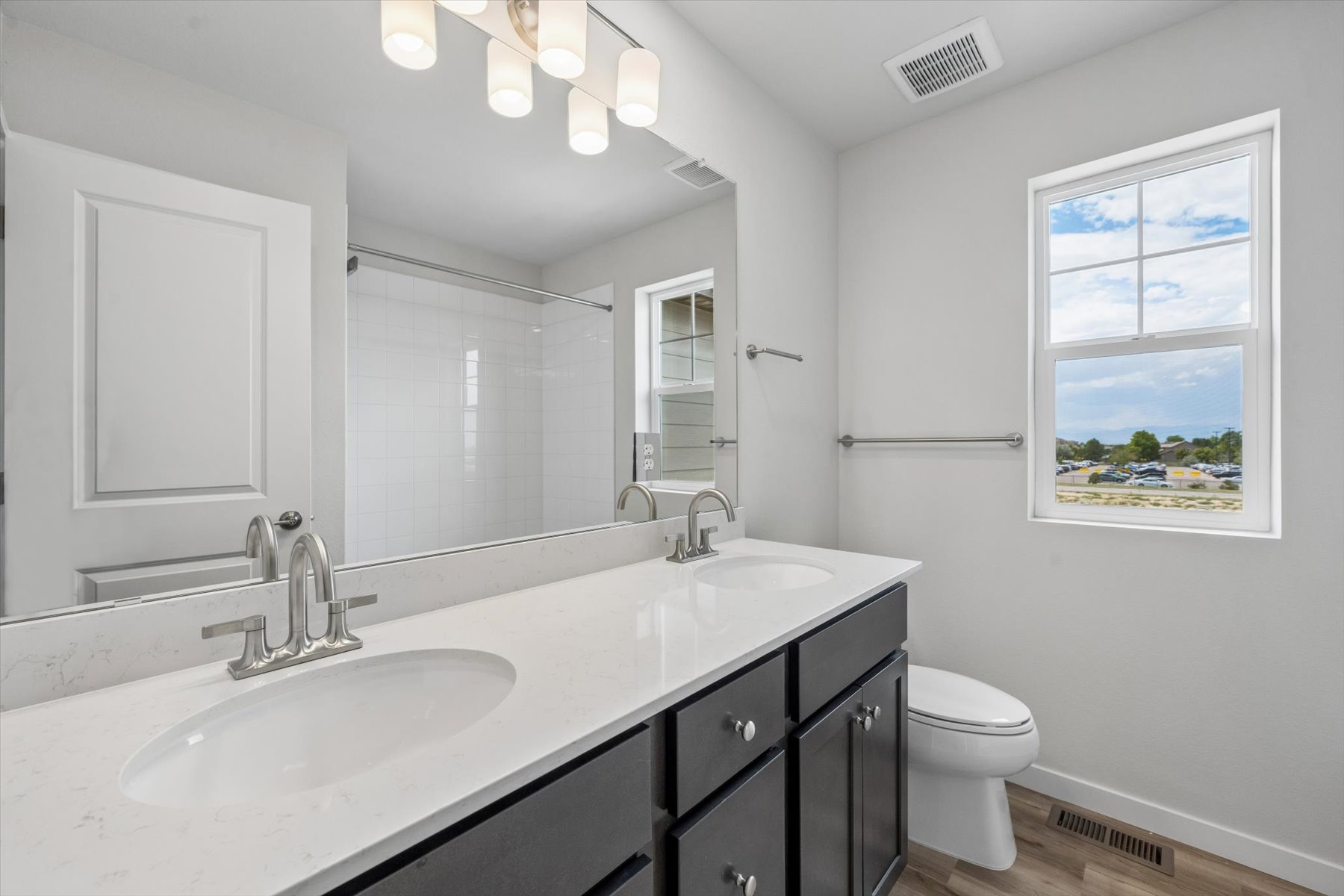 A bathroom with a large mirror.
