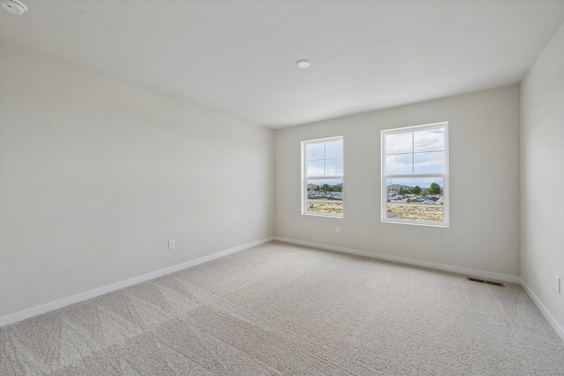 A room with a window and a carpet.