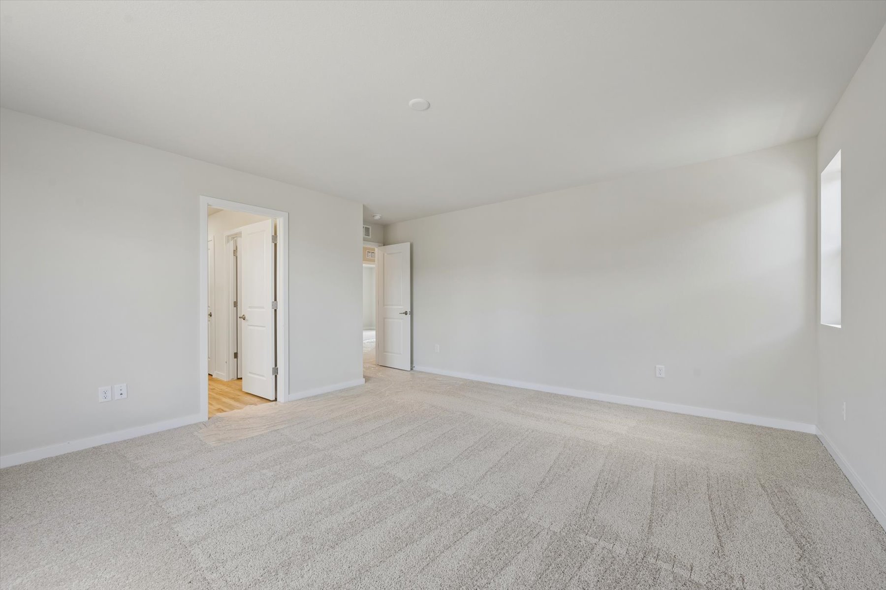 A long hallway with white walls.