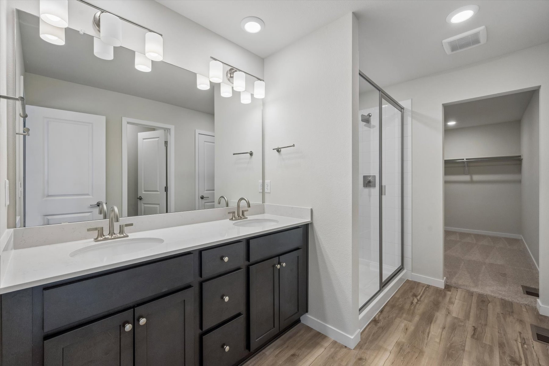 A bathroom with a large mirror.